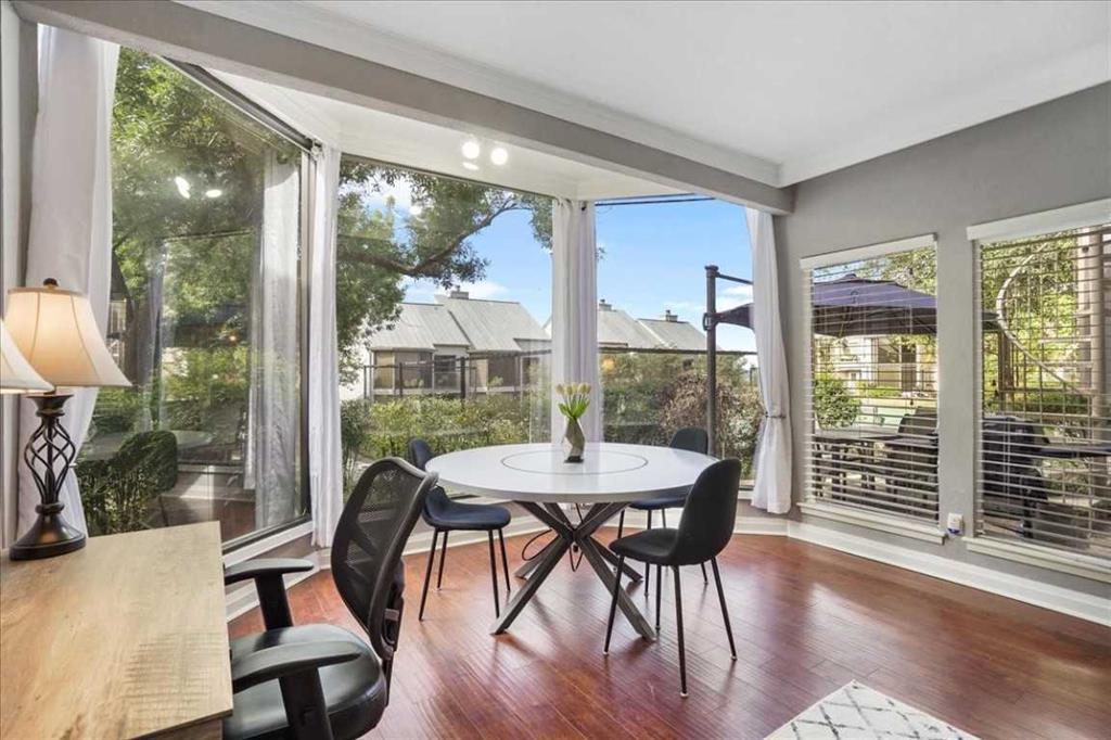 A spacious dining area features rich hardwood flo