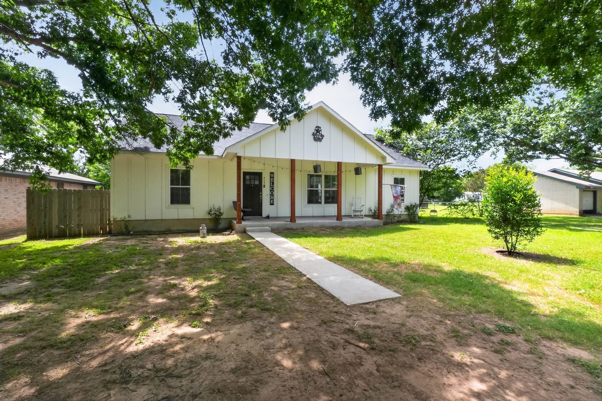 A charming cottage-style home with a welcoming fr