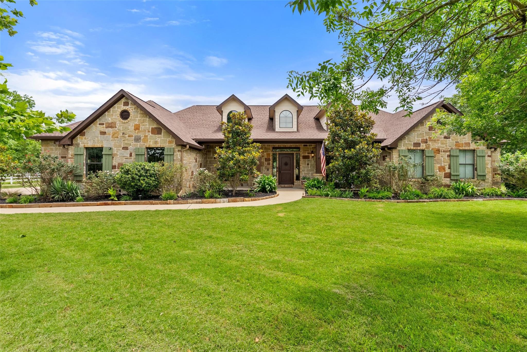 A graceful stone facade with gabled dormers frame