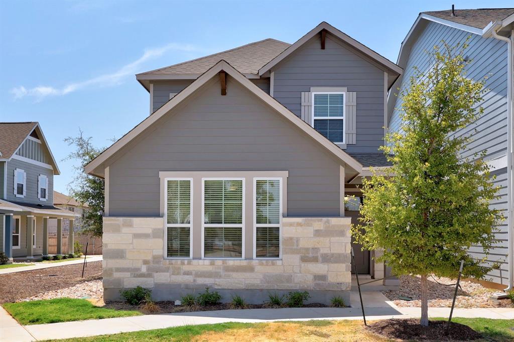 A striking facade with stone accents and grey sid
