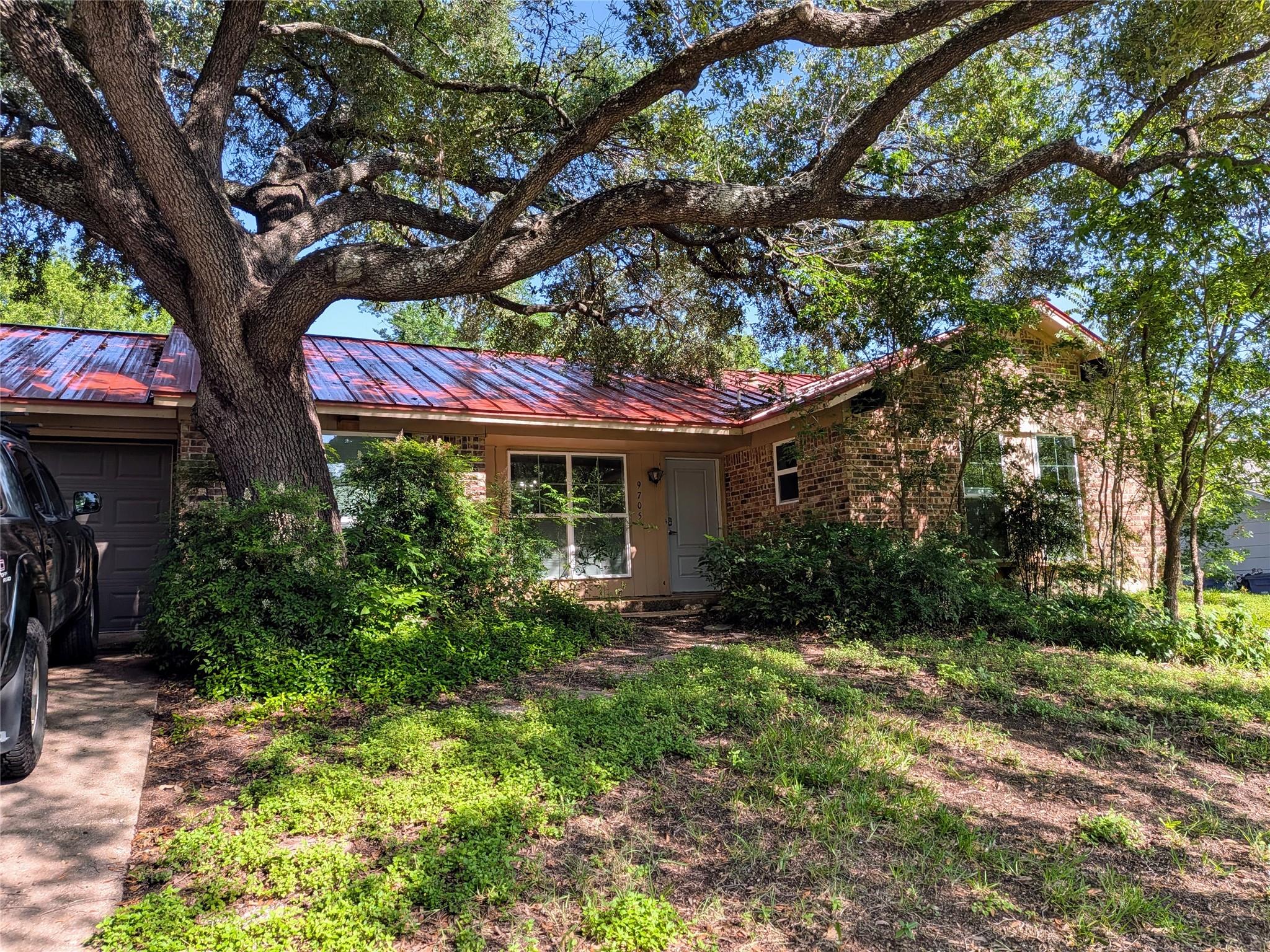 Mature trees shade this brick home with an eye-ca