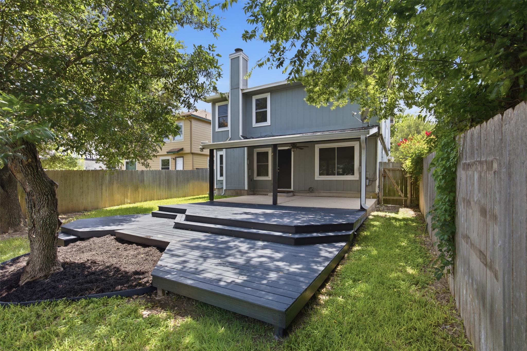 A spacious multi-level deck extends from the hous