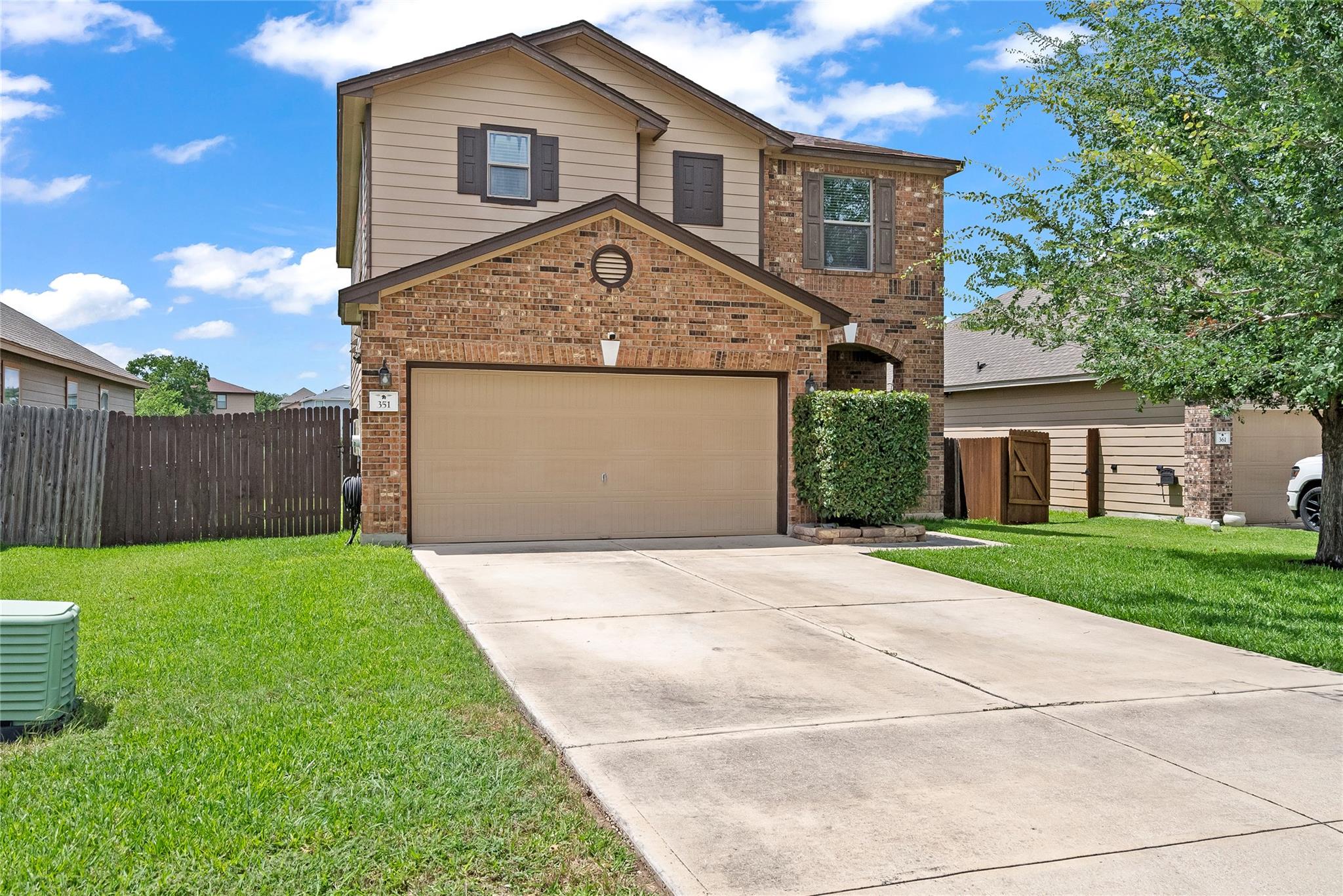 A classic brick and siding two-story home with a 