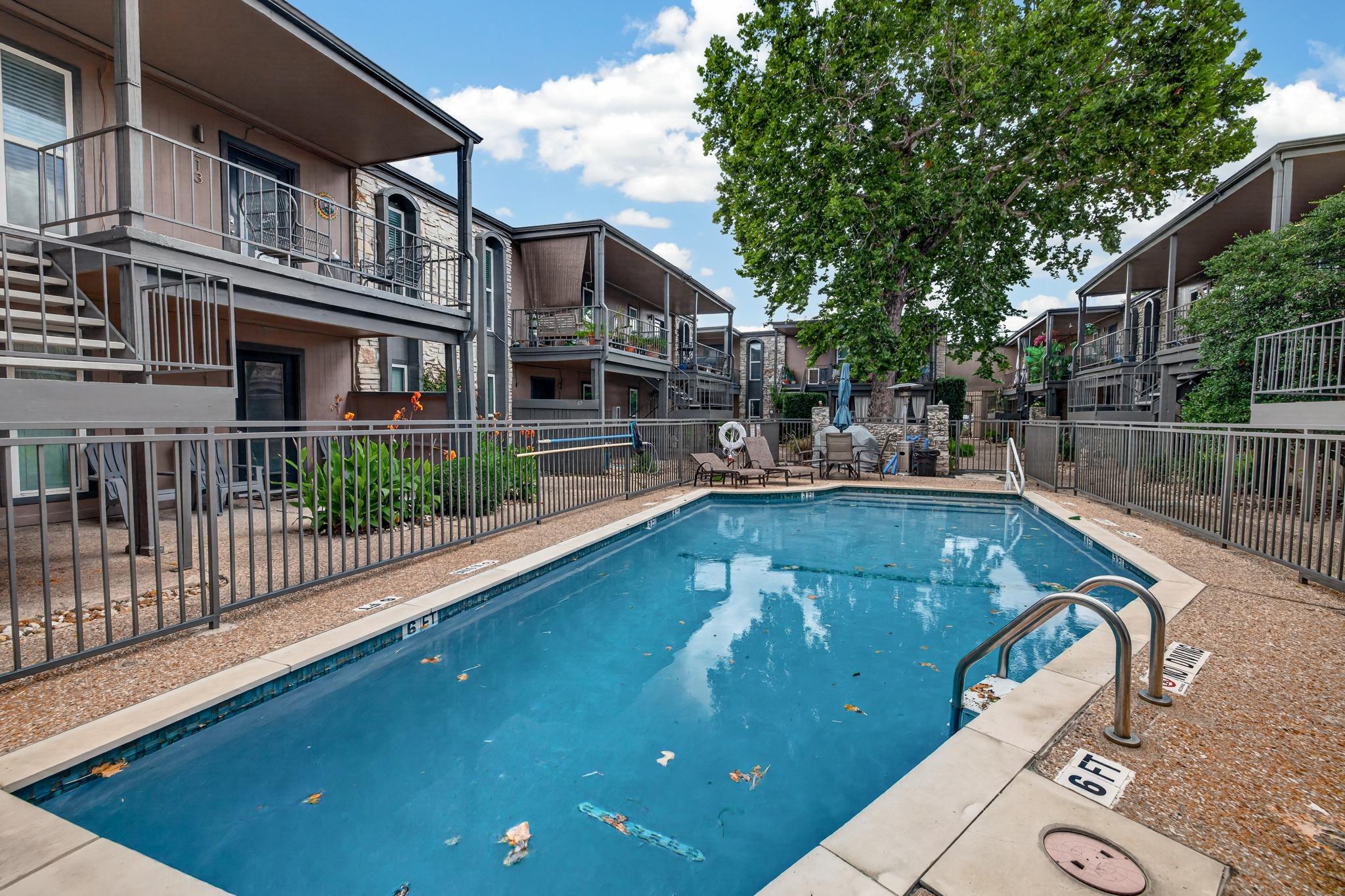 A well-maintained community pool awaits, surround