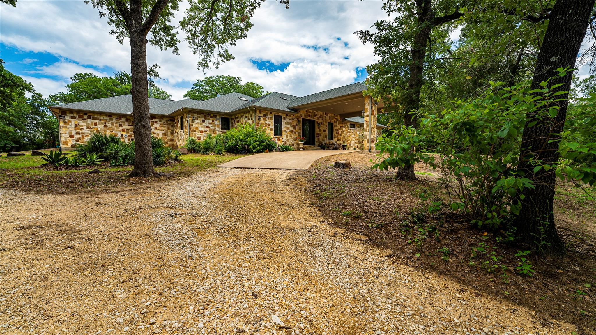 A handsome stone-clad residence nestled among mat