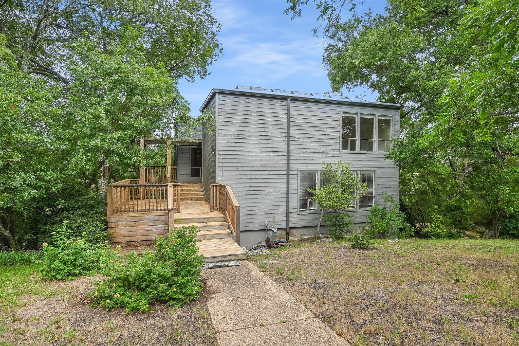 A private deck with steps welcomes you to this se