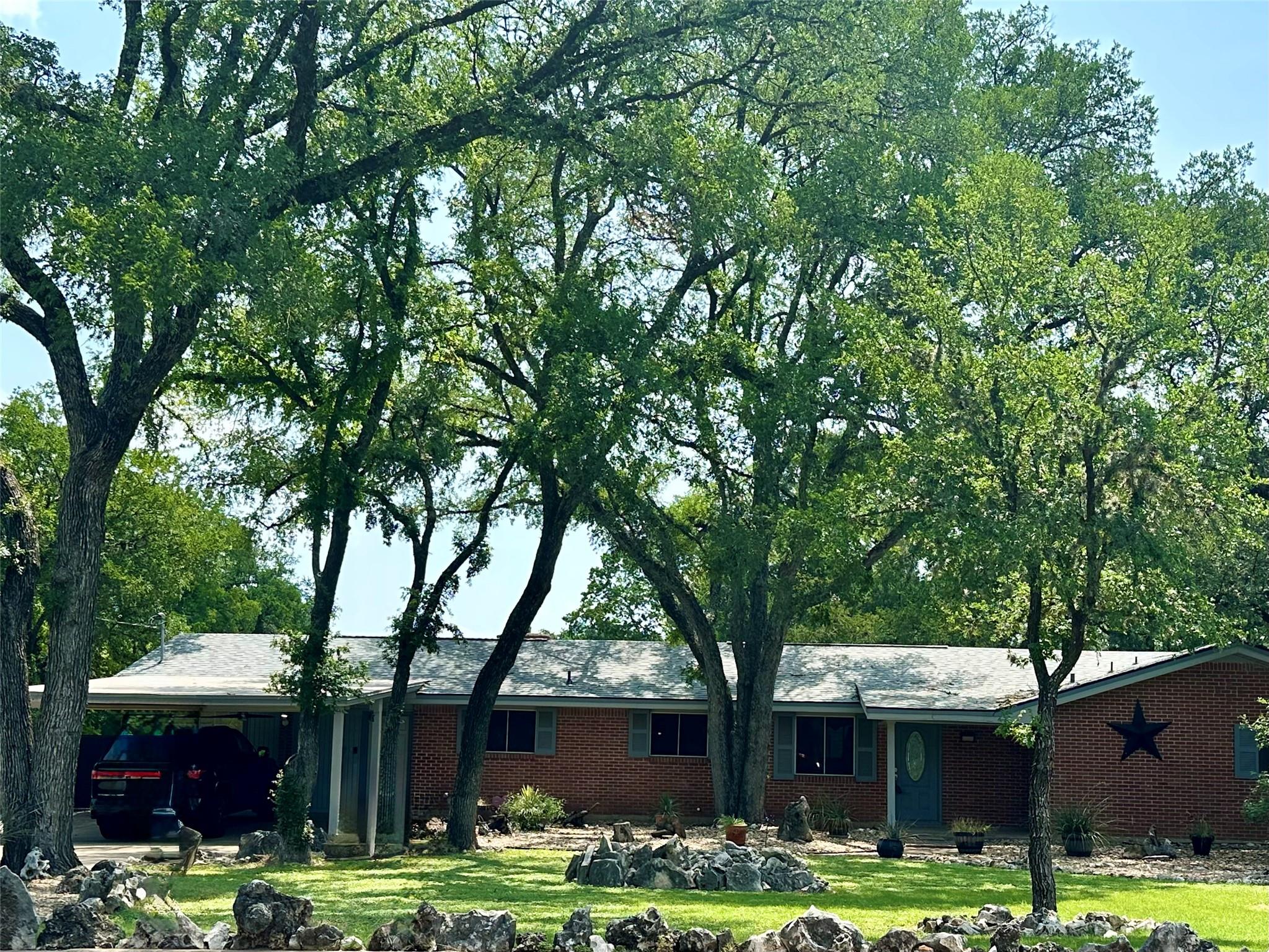 Mature trees shade this charming brick residence 