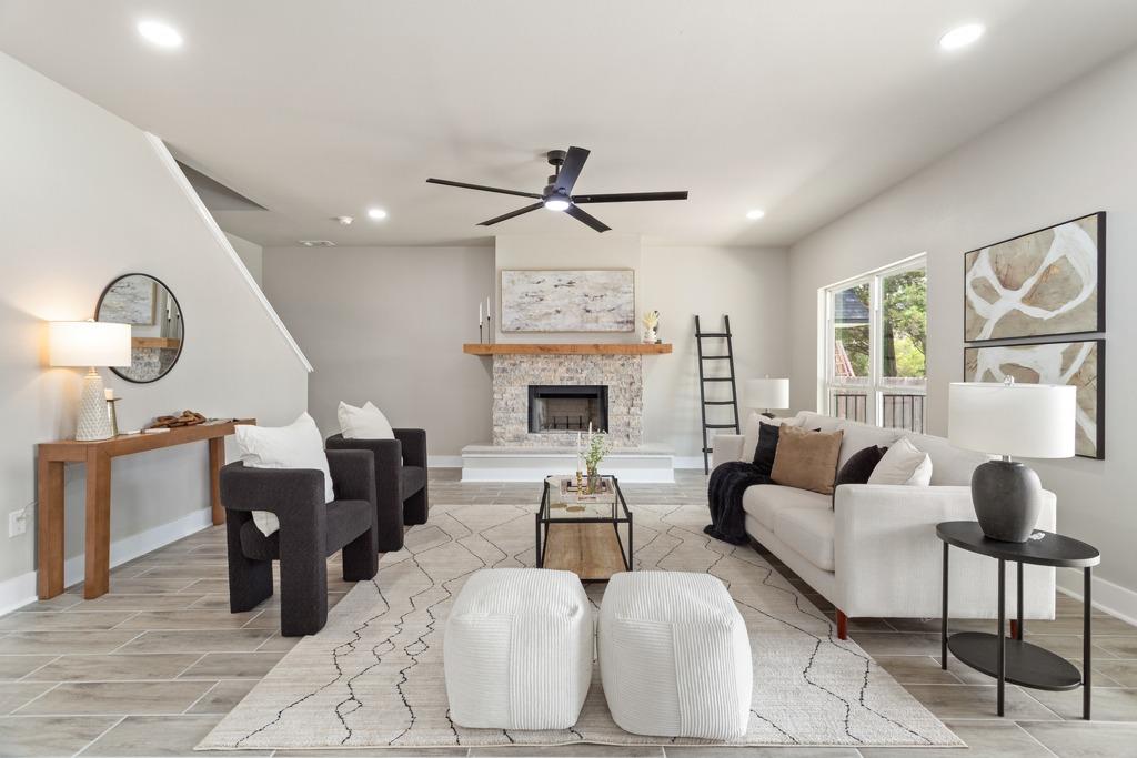 A striking stone fireplace and a dark-bladed ceil