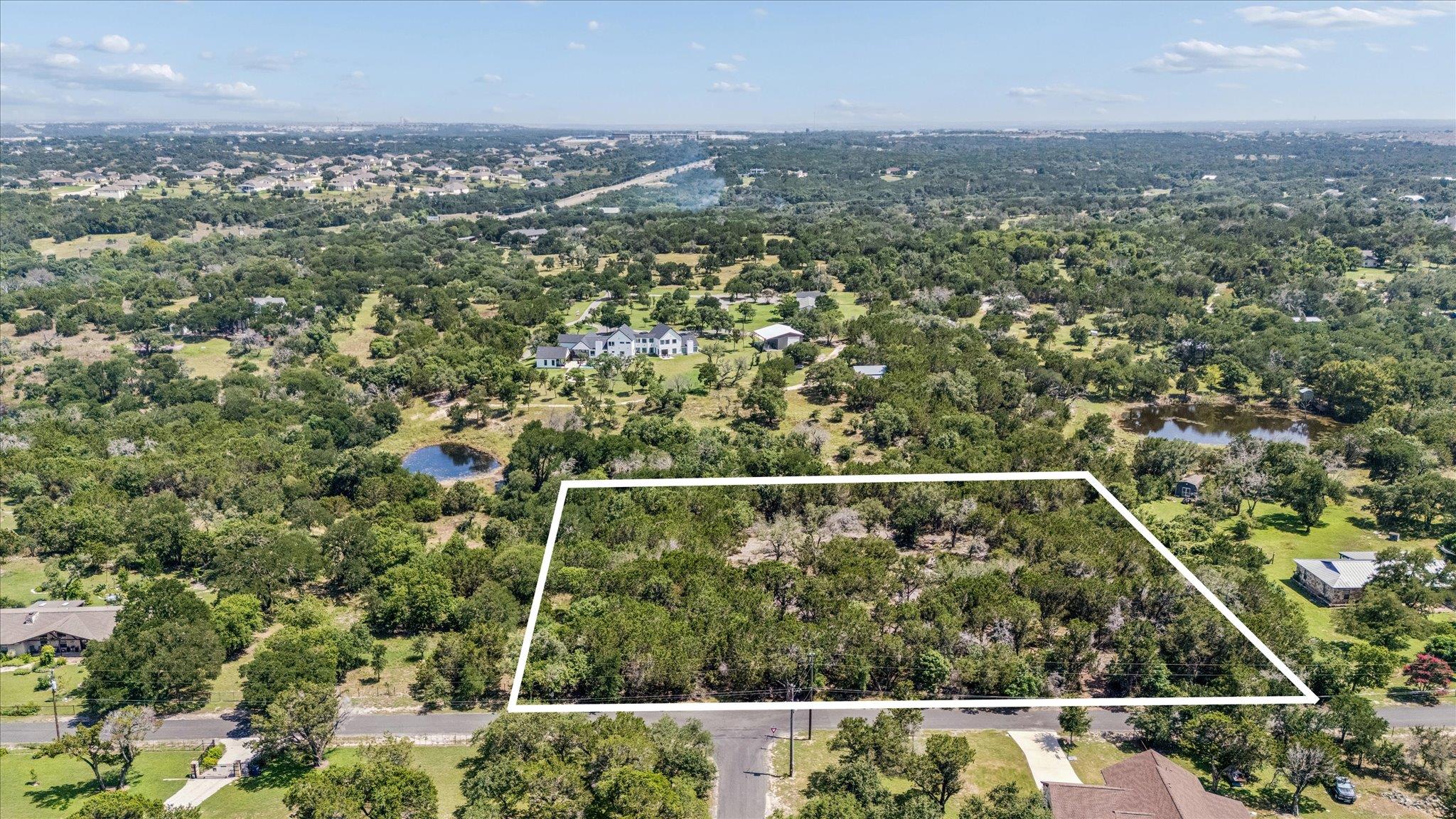 A spacious, tree-lined lot offers ample privacy a