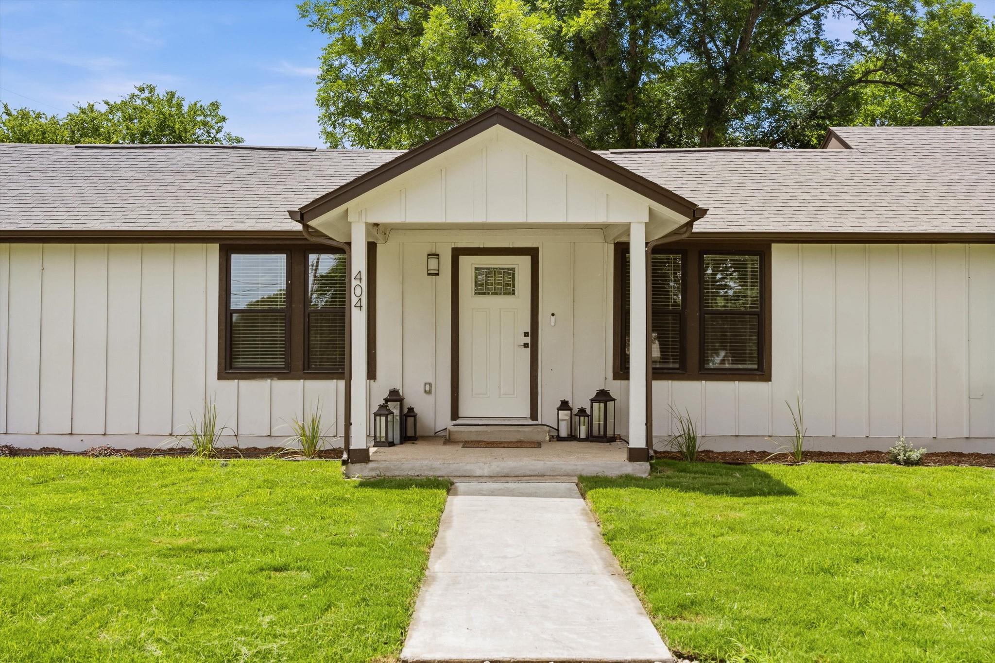 A welcoming entry, with a crisp white facade and 