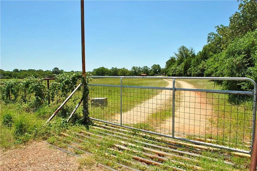 Secure gated entry to a winding dirt road through