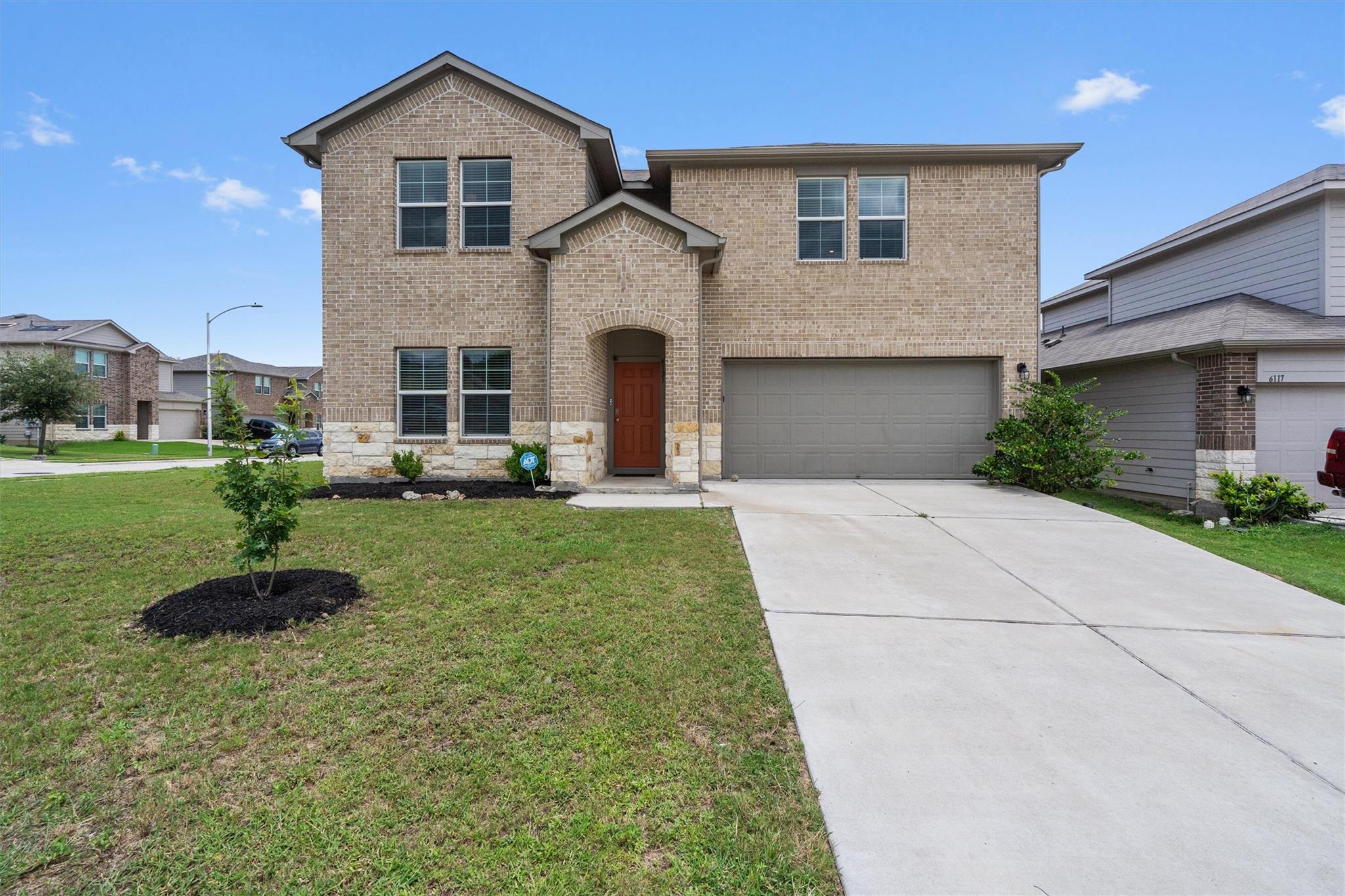 A classic brick facade with stone accents welcome