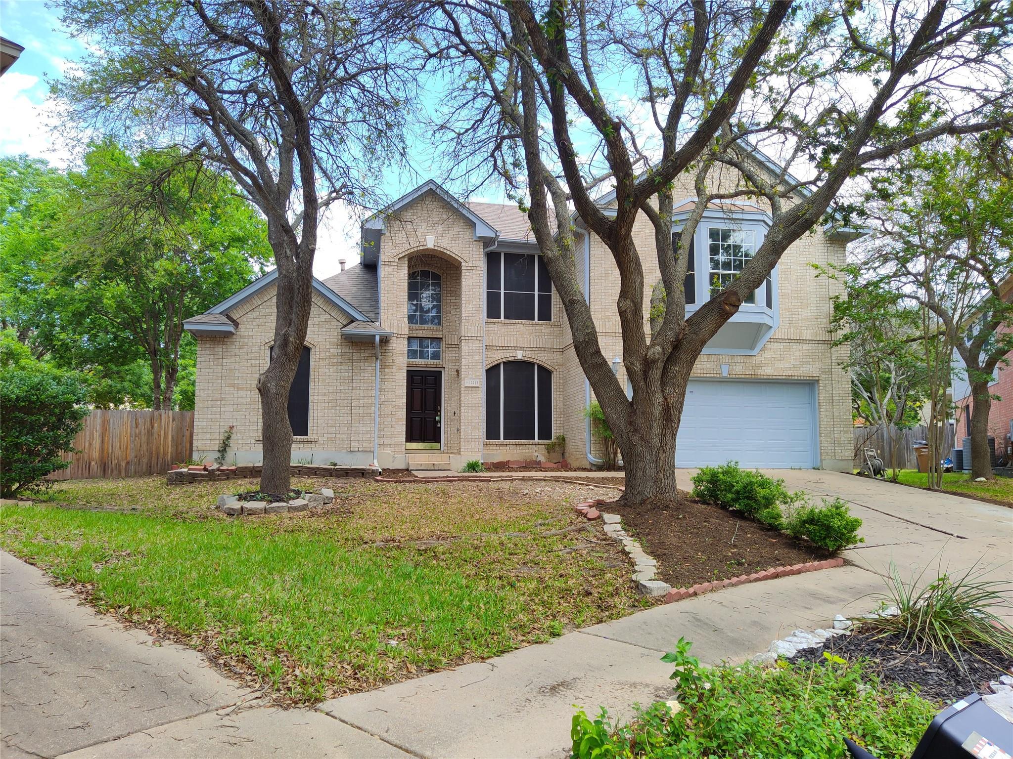 A classic brick exterior with a two-car garage pr