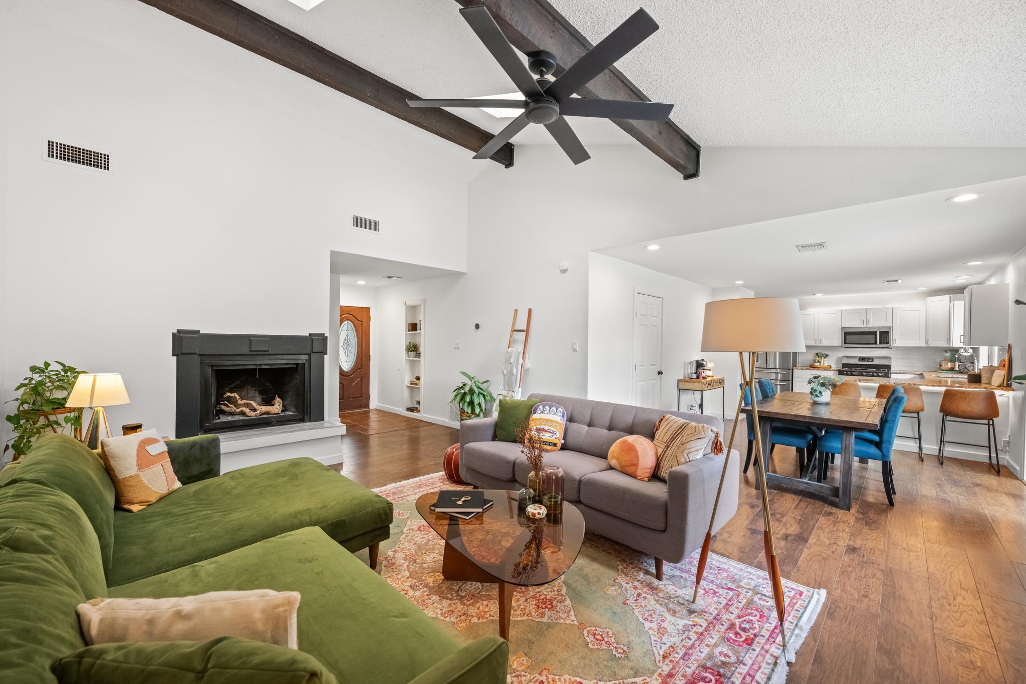 A spacious living area with exposed beam ceilings