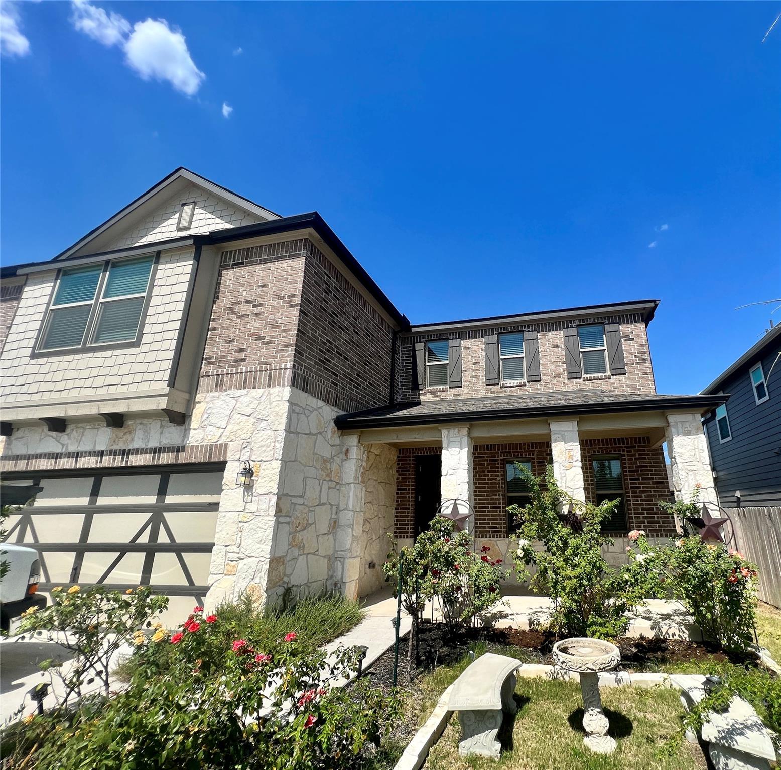 A charming two-story home with a mix of brick and