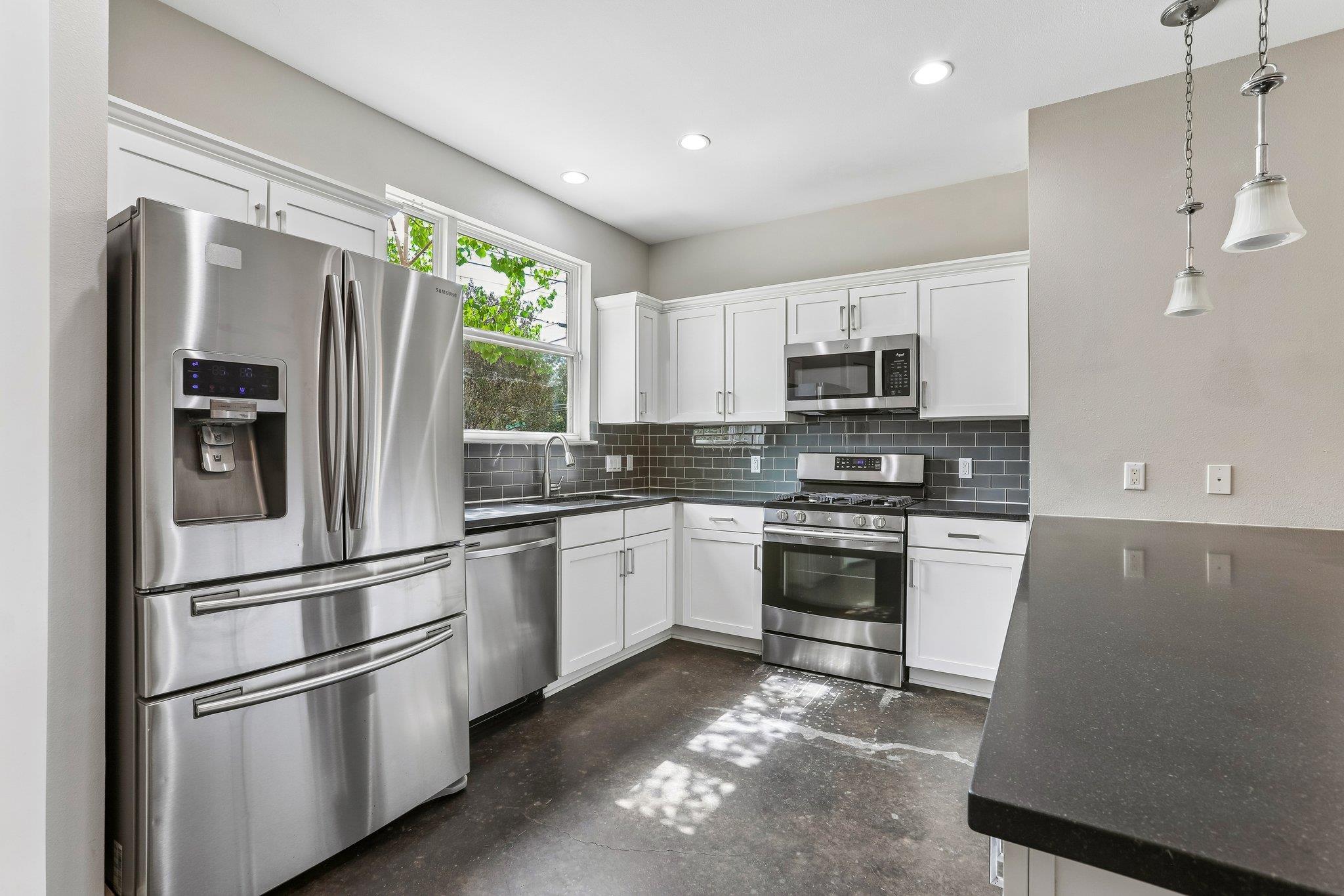 Gleaming stainless steel appliances complement th