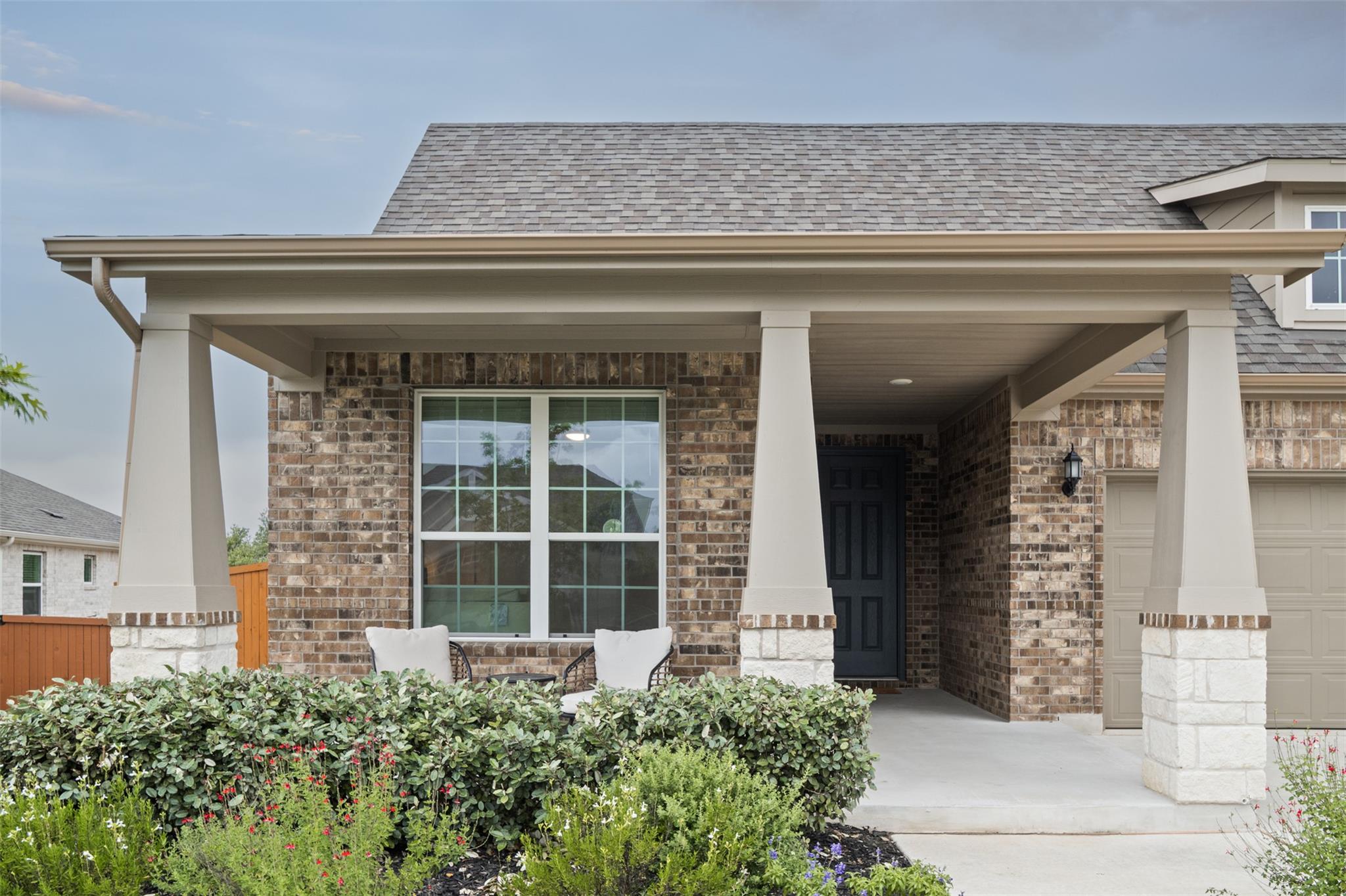 A welcoming front porch, adorned with stone and b