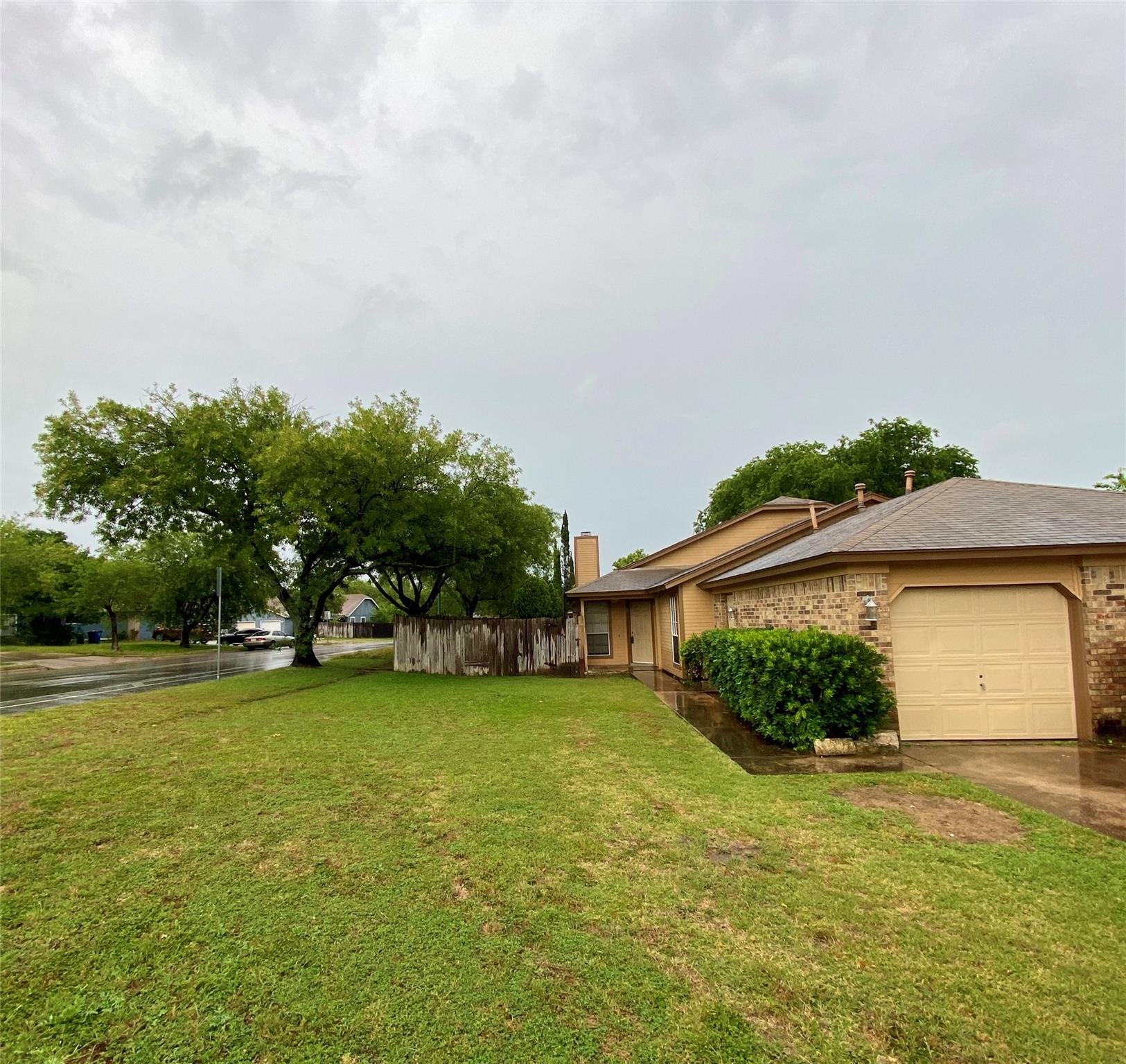 A well-maintained lawn leads to this charming res