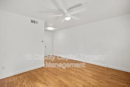 Natural wood-look flooring extends throughout thi