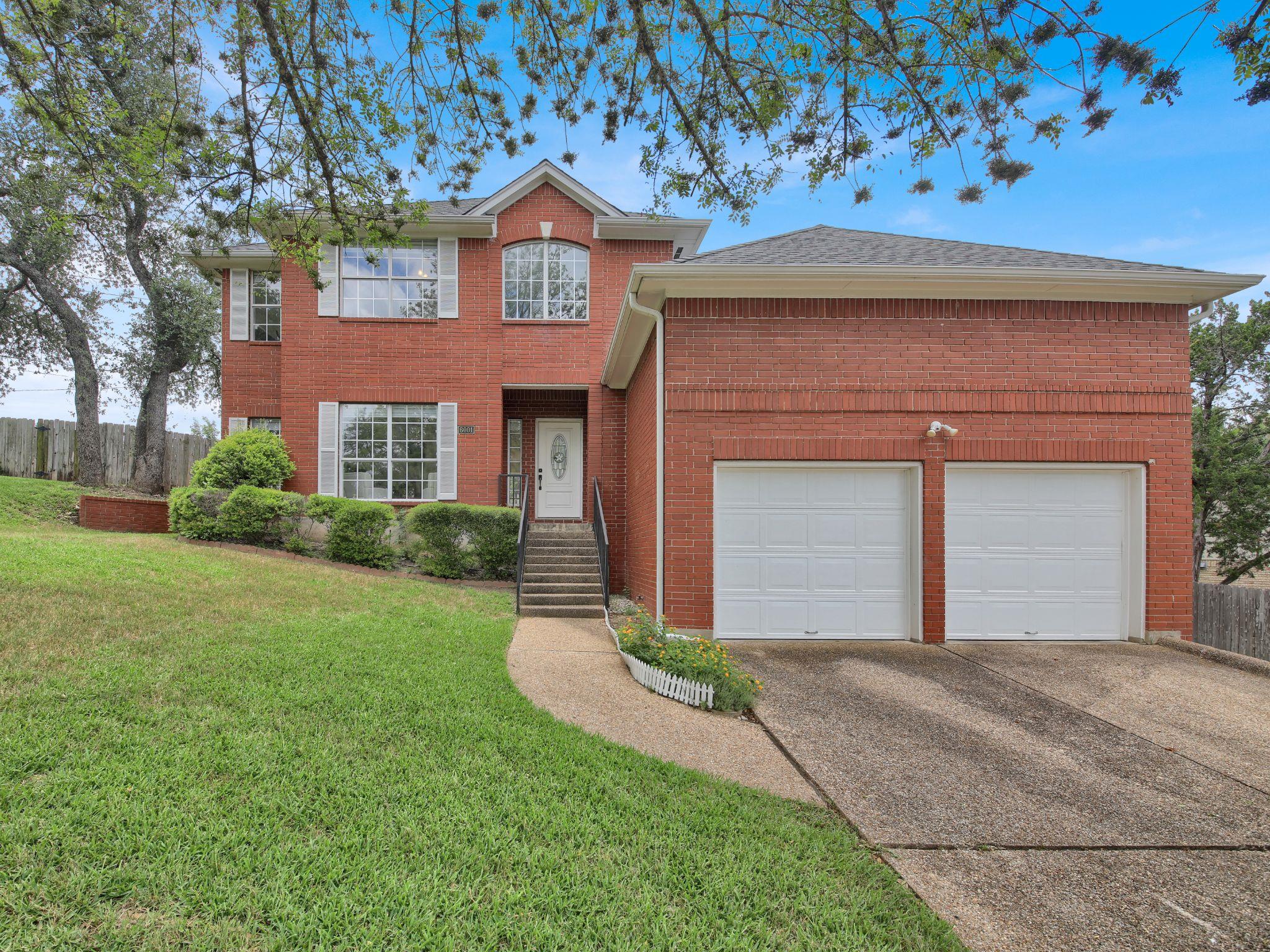 A classic red brick exterior welcomes you home wi