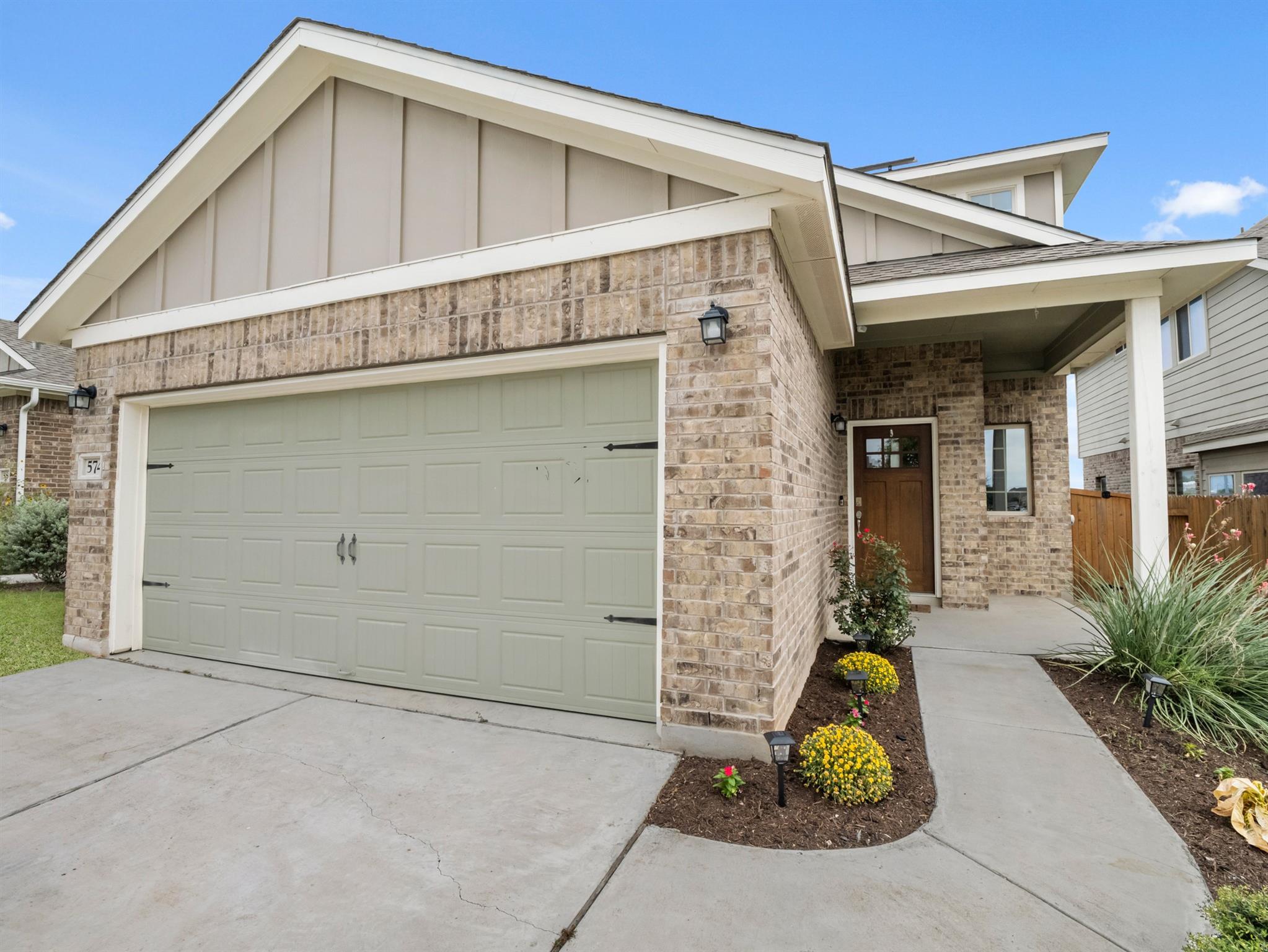 A welcoming brick facade with a prominent garage 