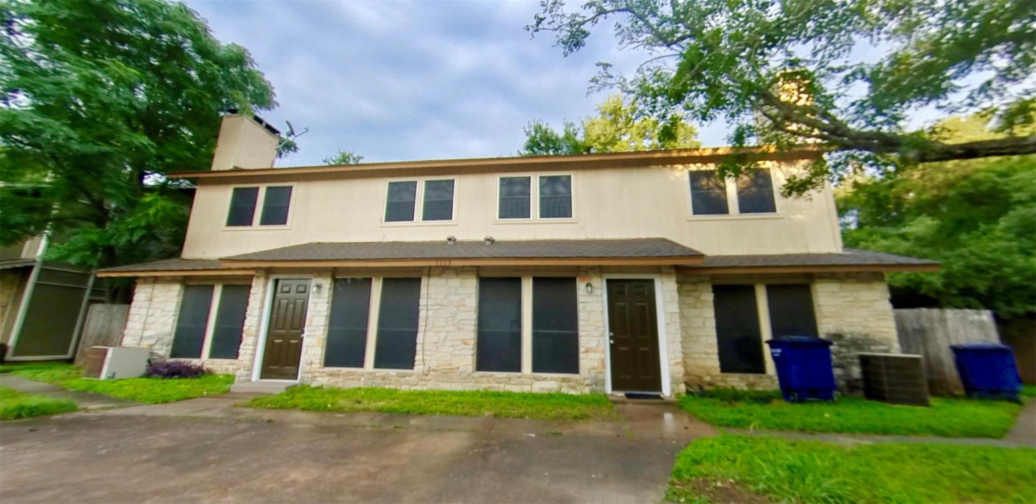 Two-story stone and stucco facades define this in