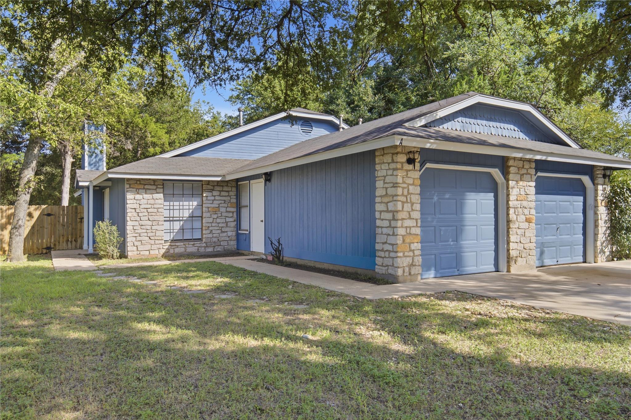 A welcoming facade features charming stone accent