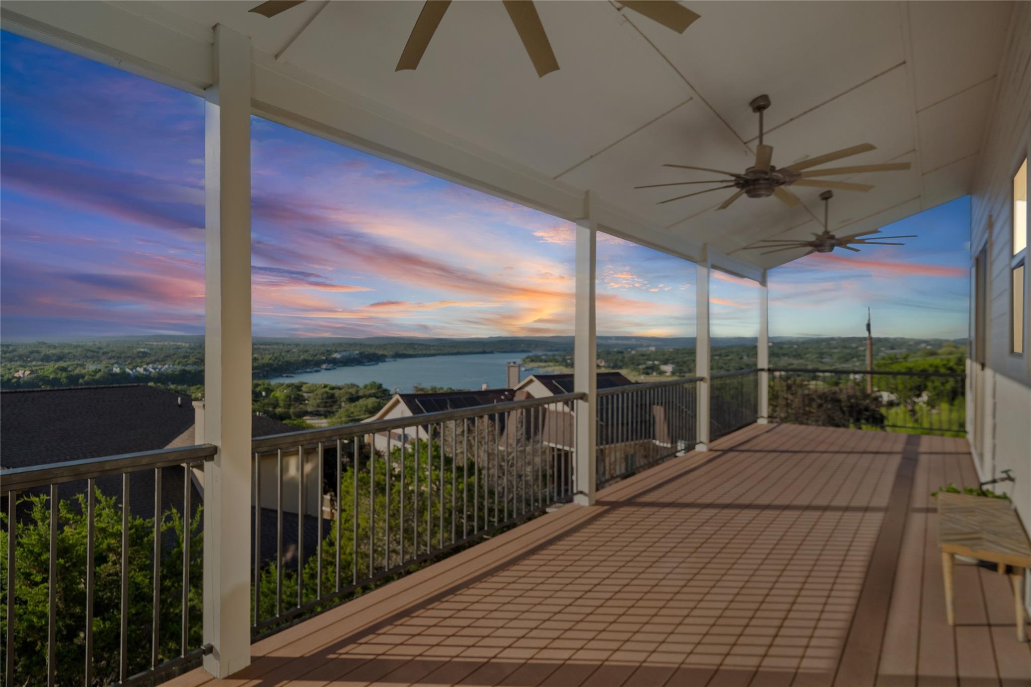 A spacious covered deck with ceiling fans offers 