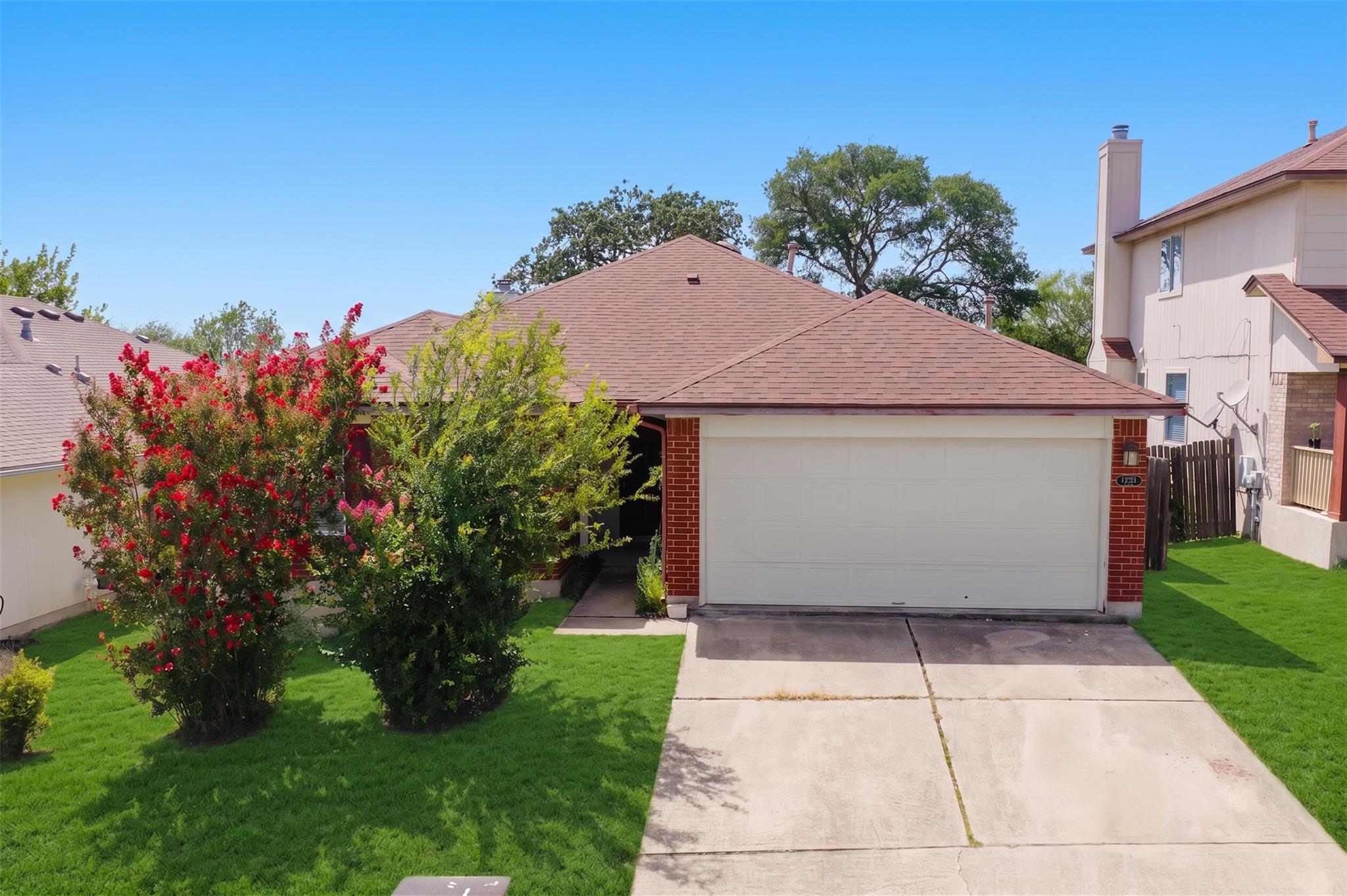 Well-maintained front lawn with mature landscapin
