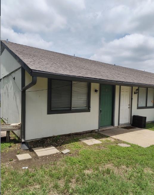 A modest building offers two separate entryways, 