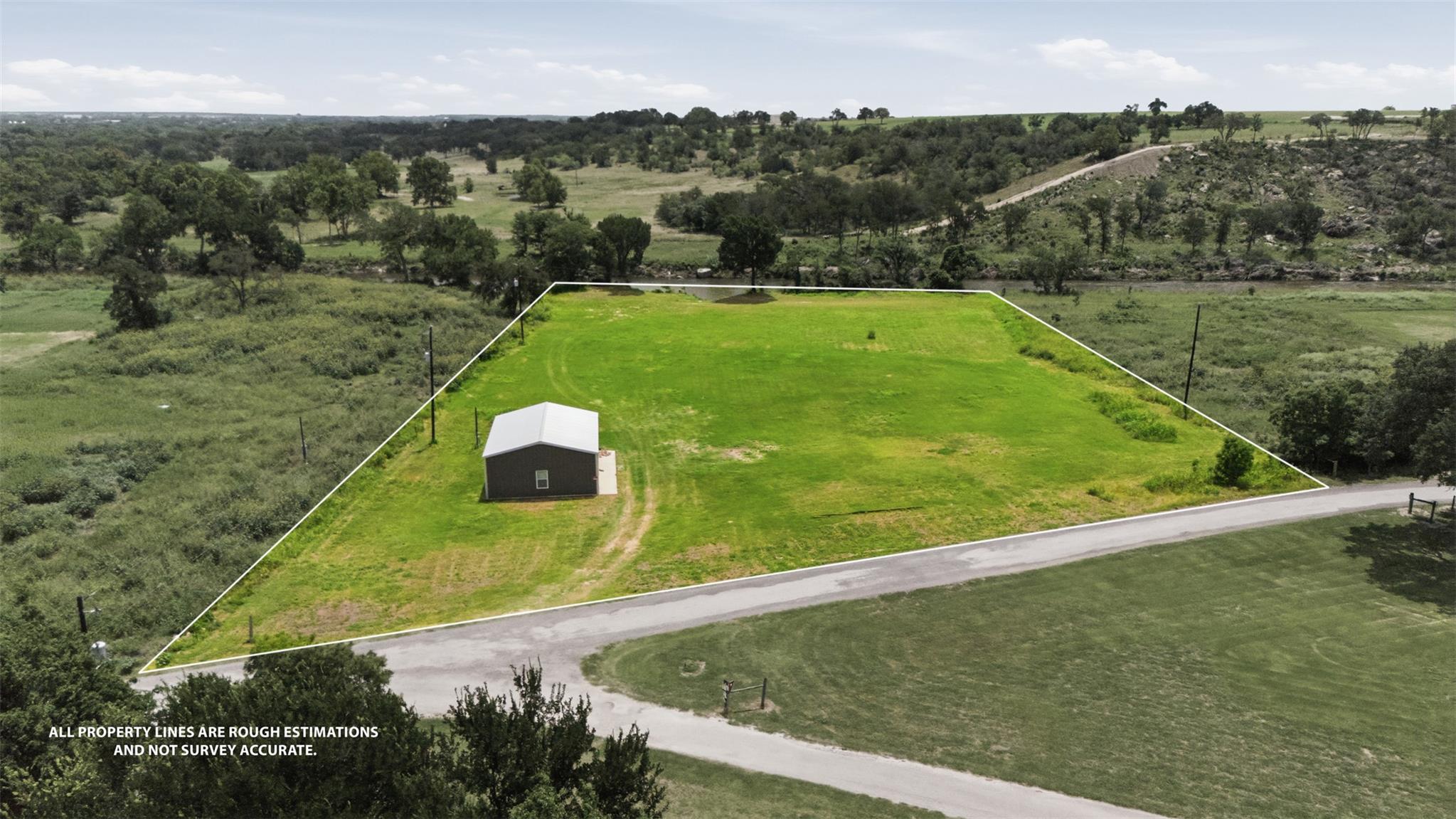 A sprawling greenspace with a utility building of