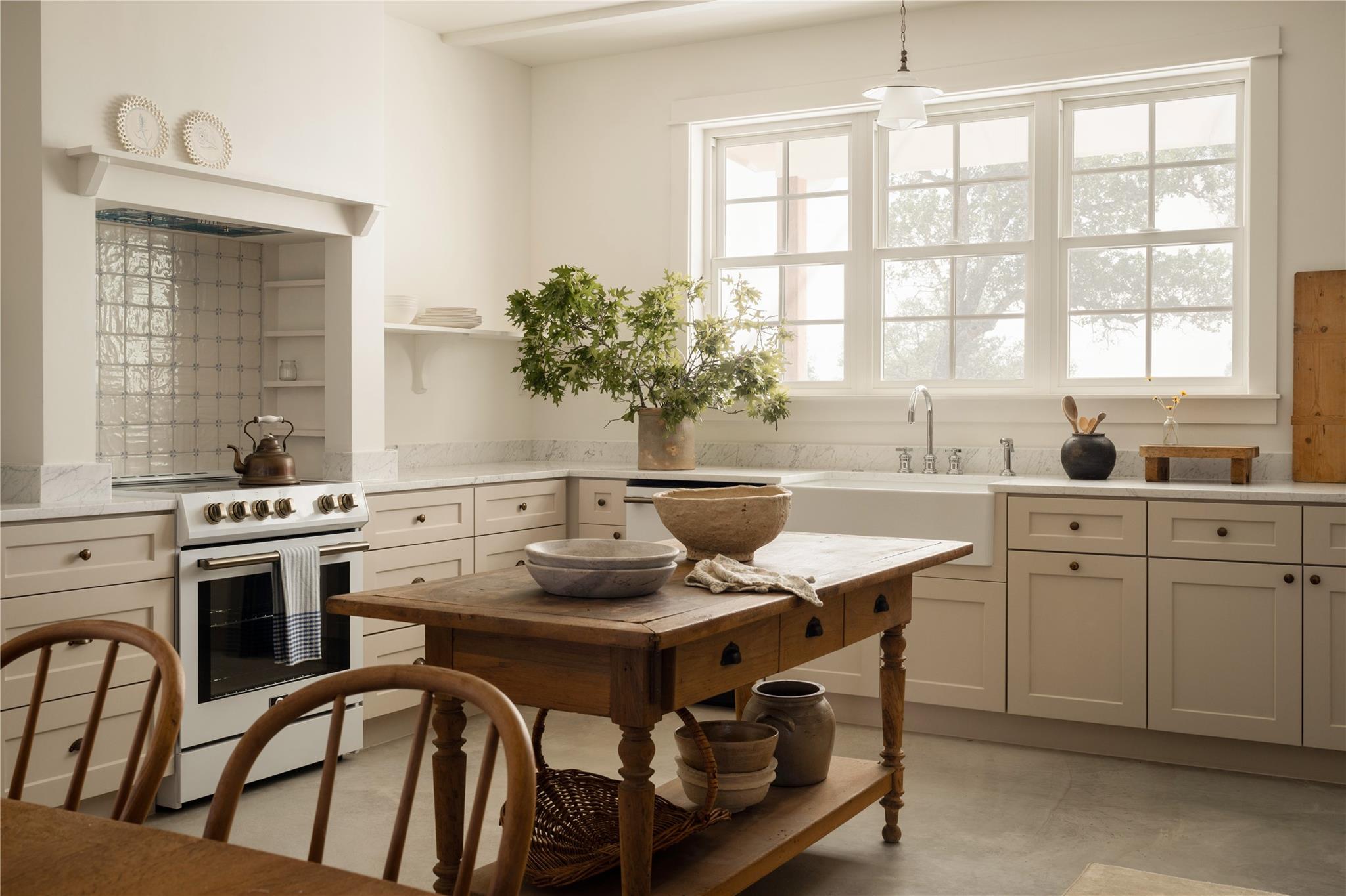 A farm-style kitchen features a spacious sink ben
