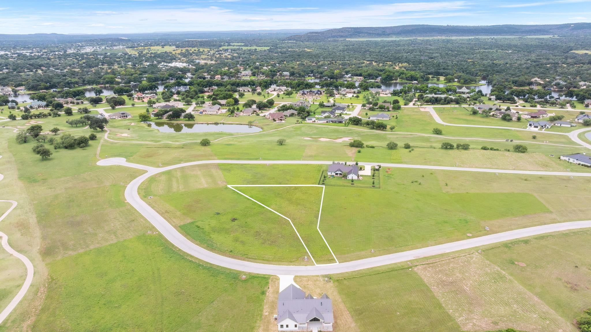 A verdant golf course community offers serene lak