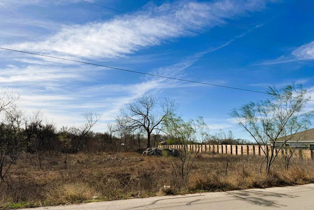A spacious, undeveloped lot awaits your vision, b