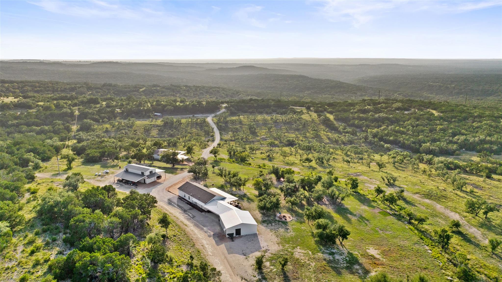 Vast, verdant landscape with scattered structures