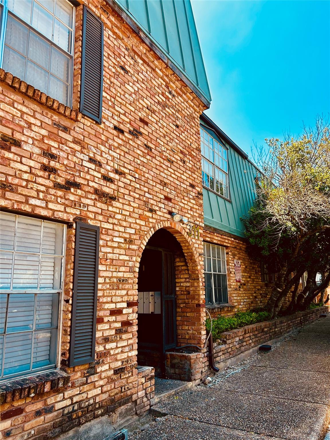 A charming brick exterior with a distinctive arch