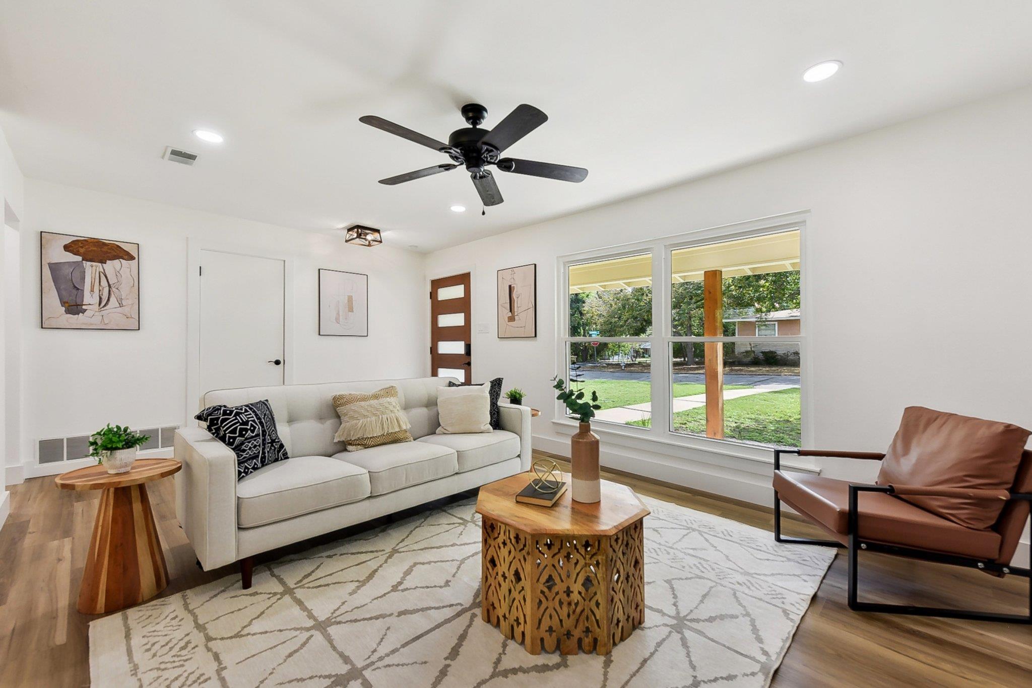 Well-lit living area showcases a comfortable layo