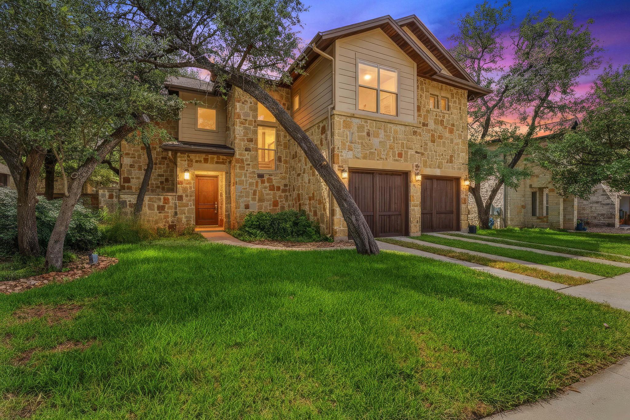 Natural stone and siding define the exterior of t