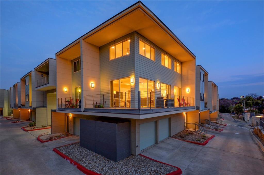 Contemporary multi-level residences glow warmly a