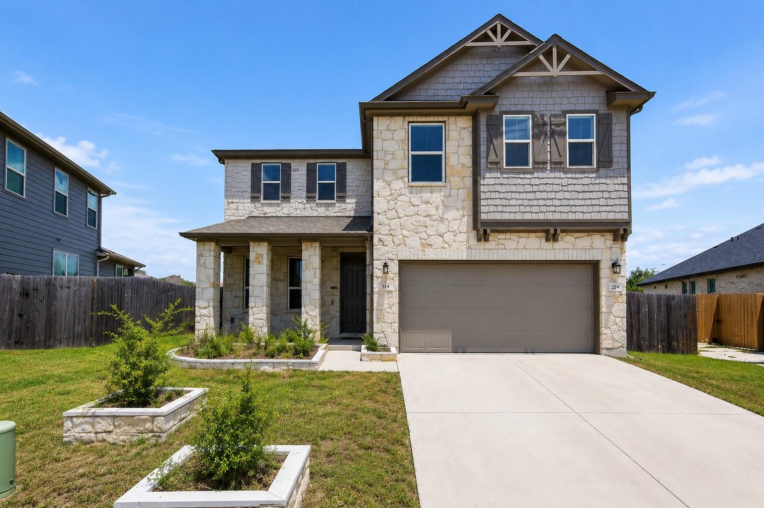 A welcoming facade boasts a stone and shingle ext