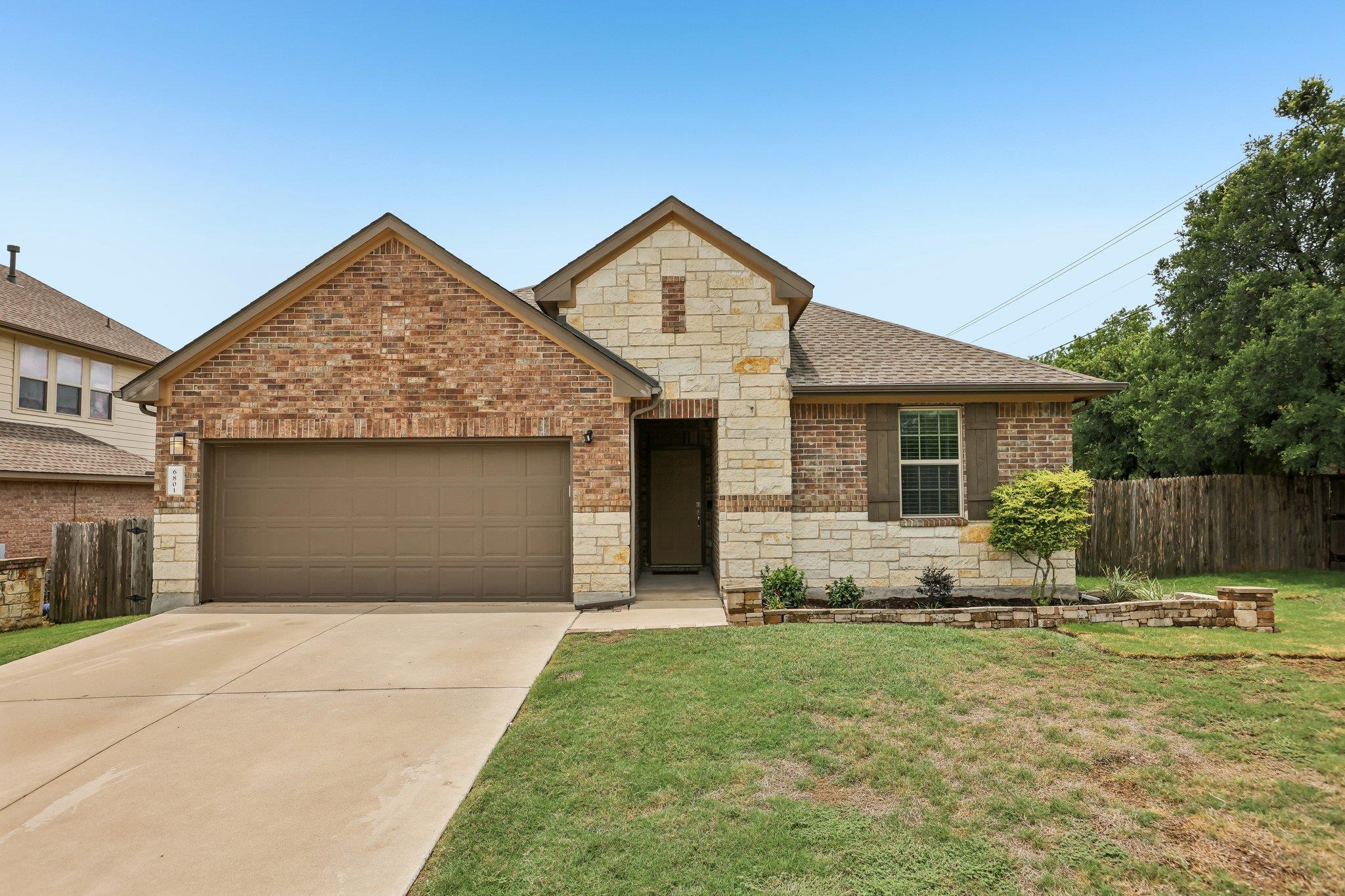 A charming blend of brick and stone accents creat