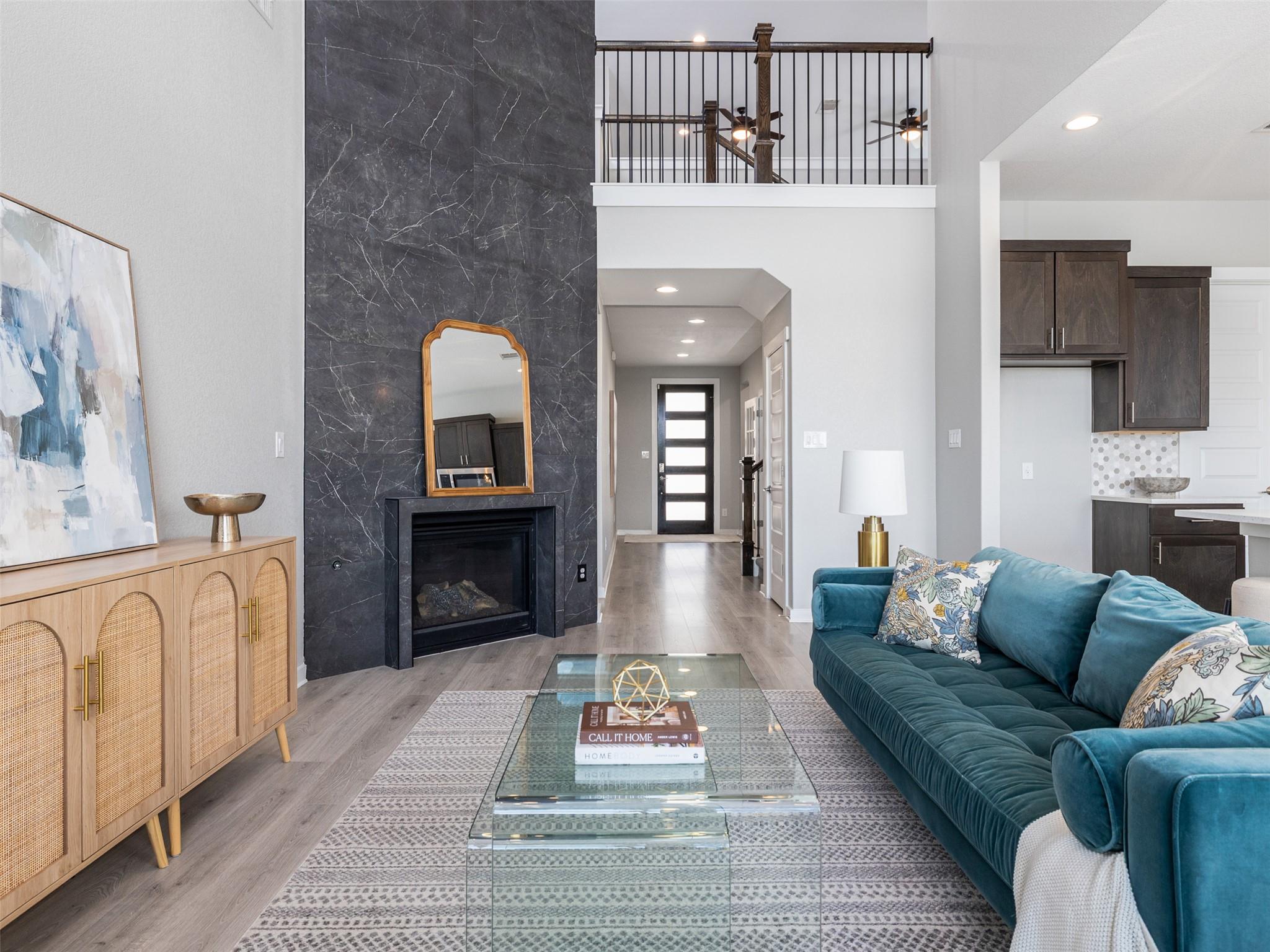 A striking floor-to-ceiling fireplace anchors thi