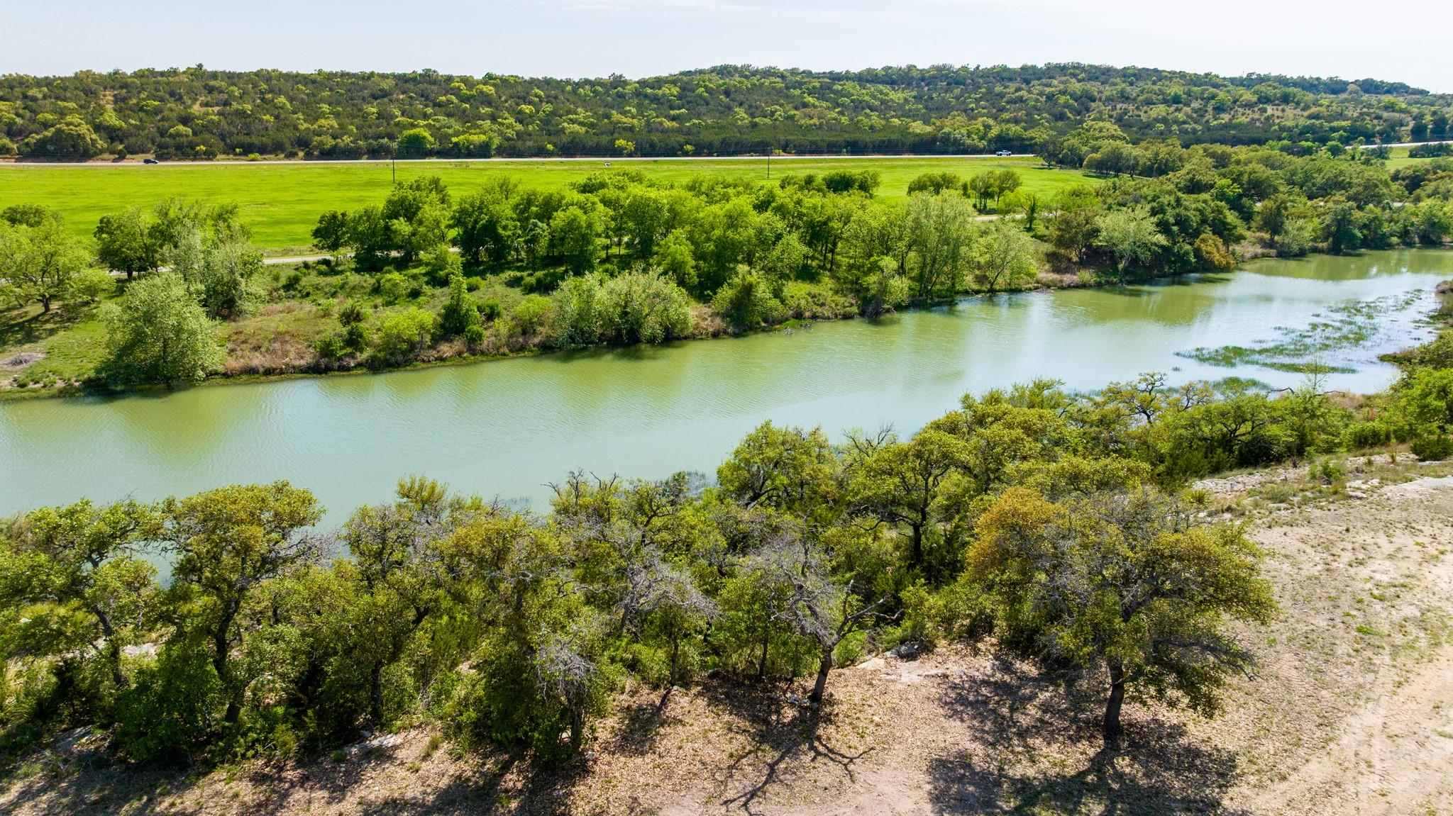 Bird's eye view with a wooded view and a water vi