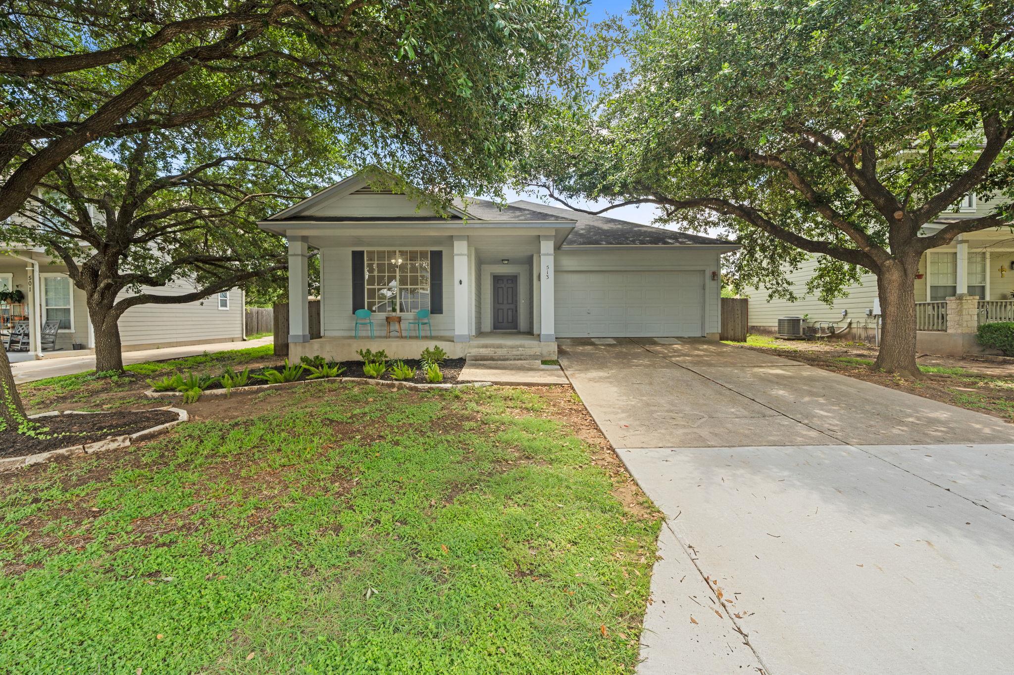 A welcoming facade with a covered porch and matur
