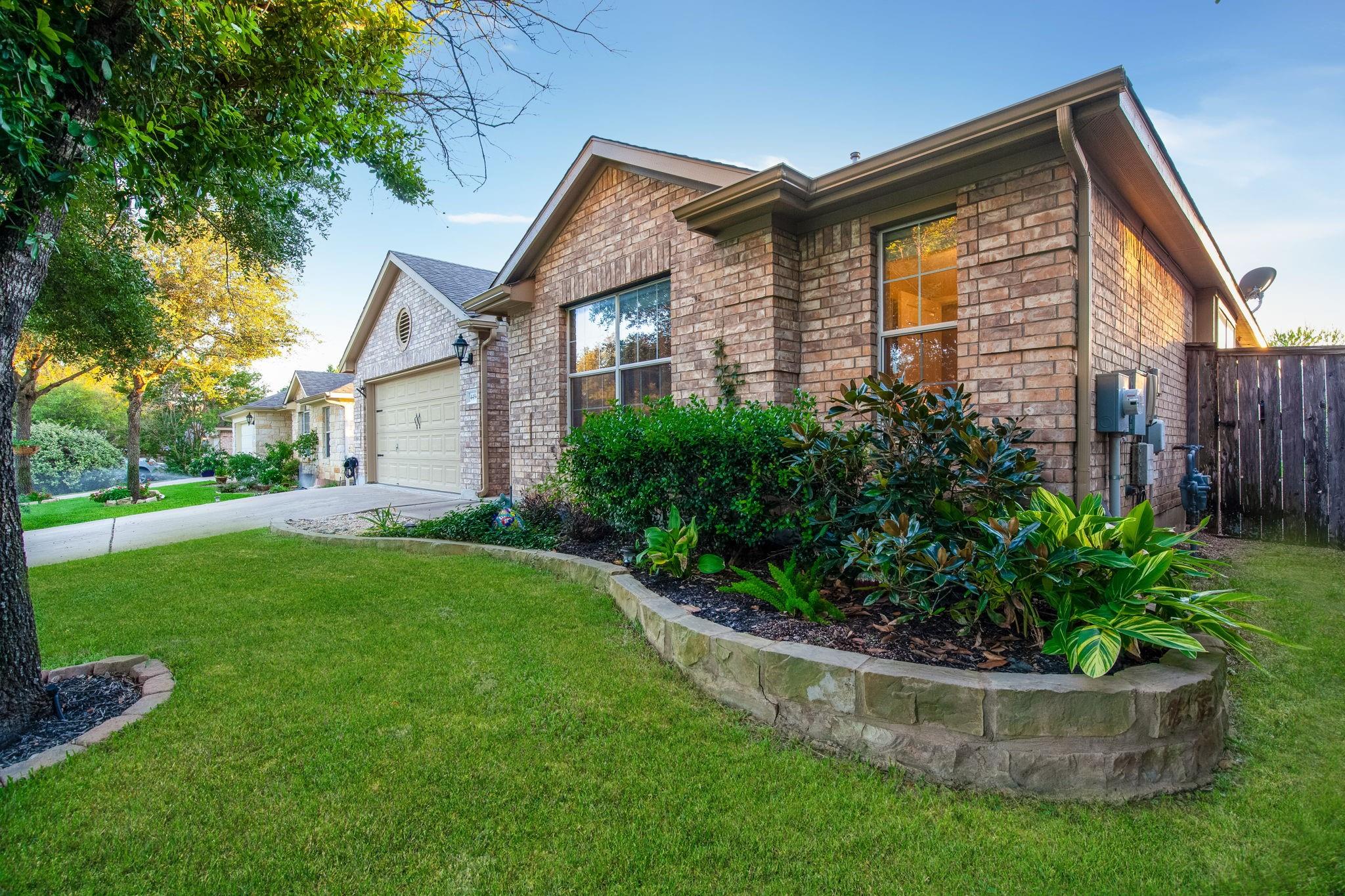 Textured brick walls and manicured green lawn cre