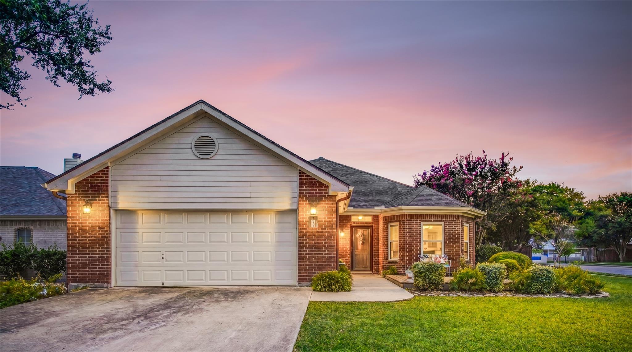 A charming brick exterior home with well-manicure