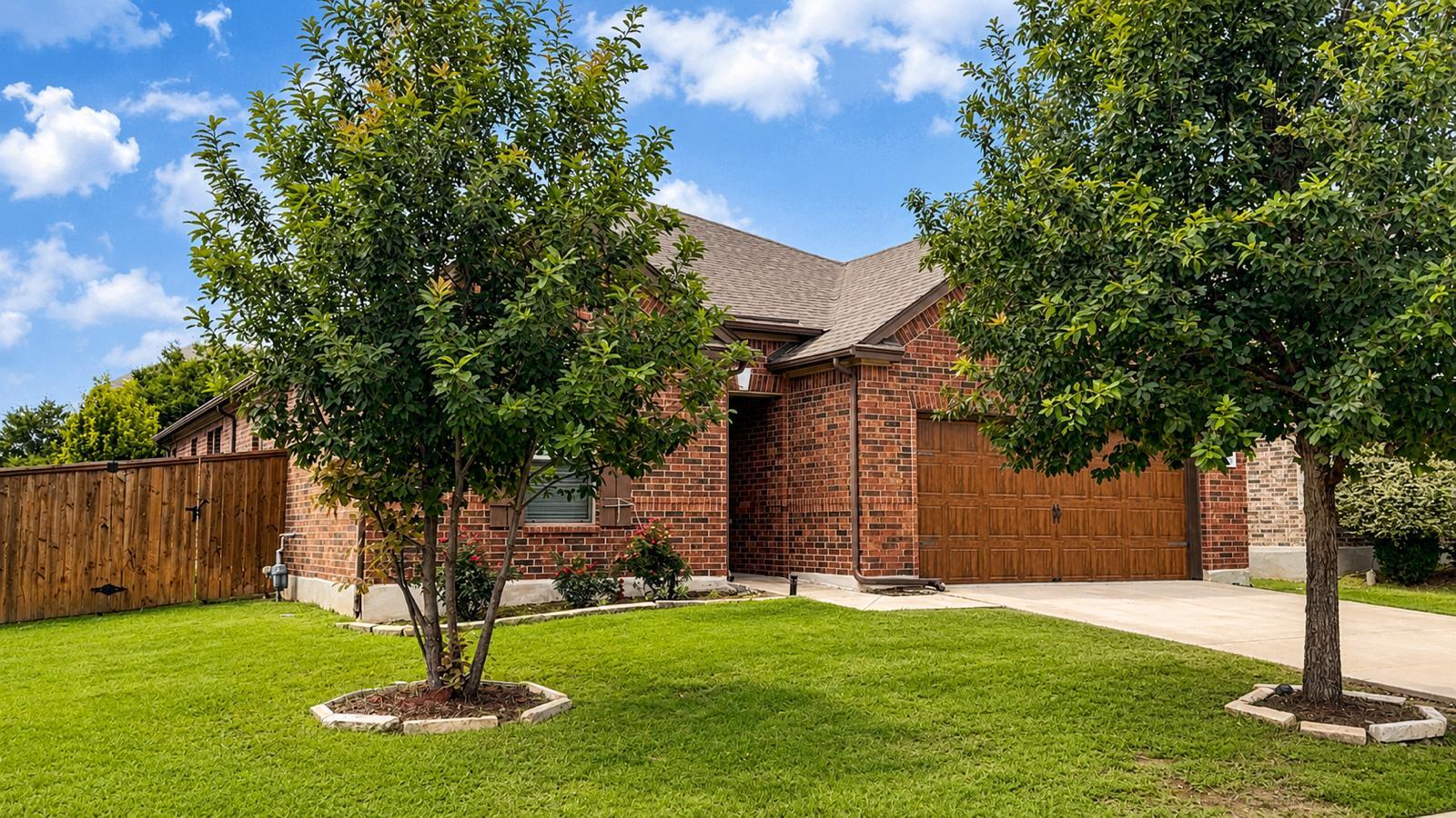 Mature trees frame this traditional brick residen