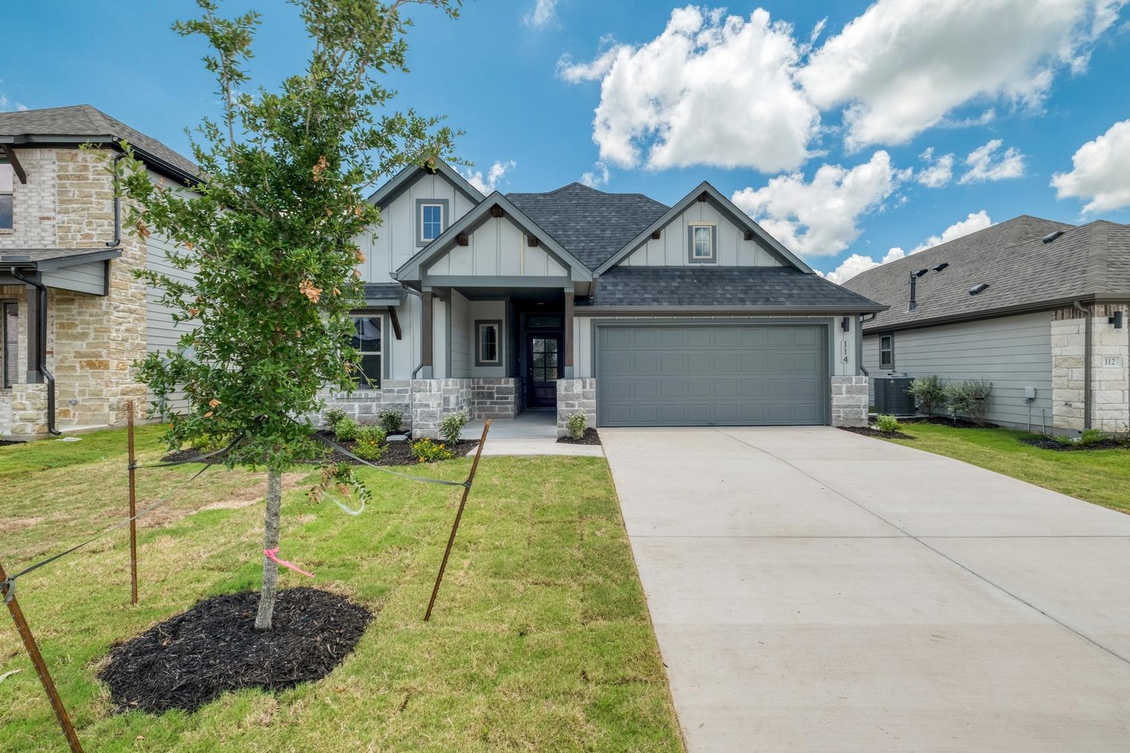 A well-maintained lawn and extended driveway gree