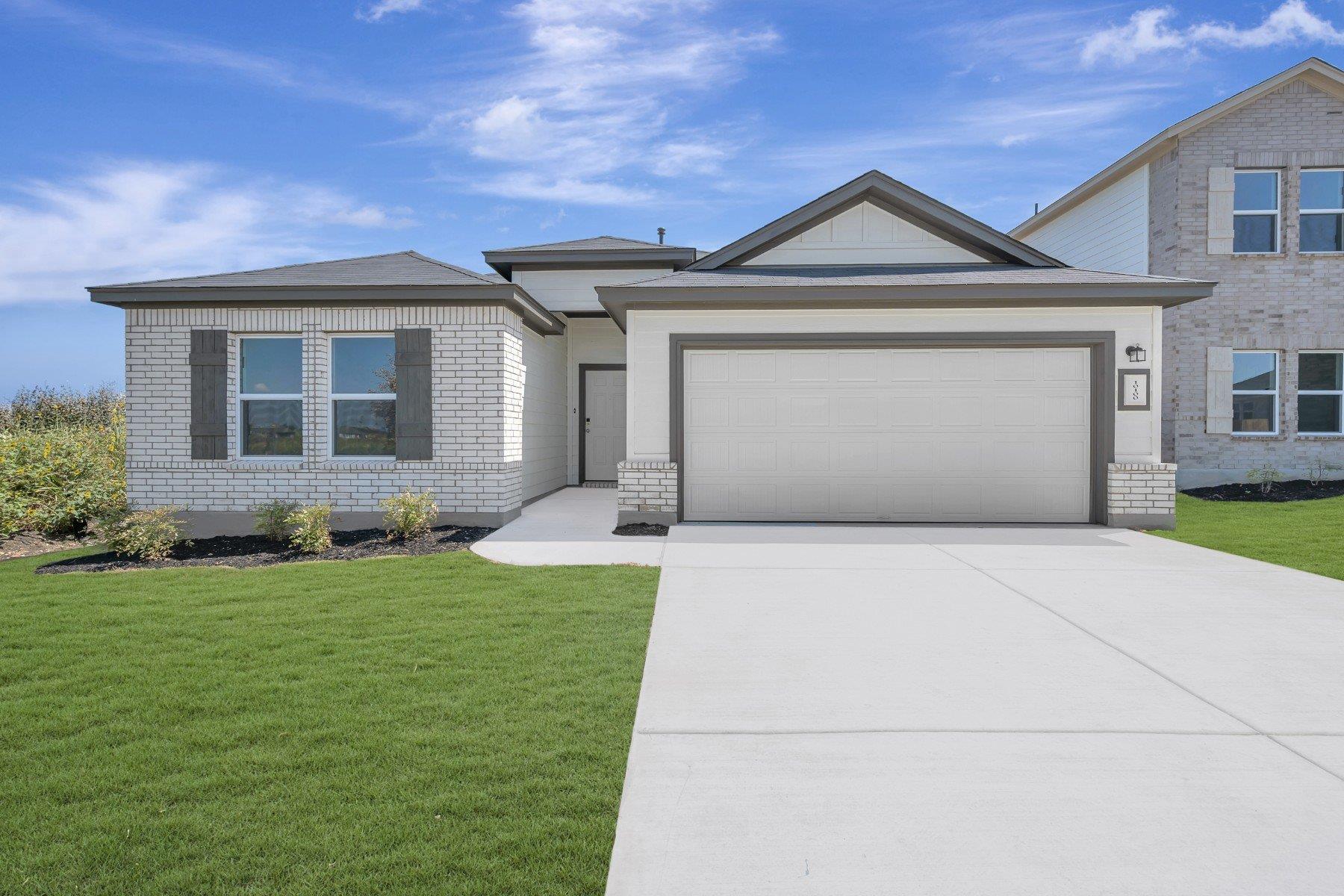 A well-maintained lawn and extended driveway welc