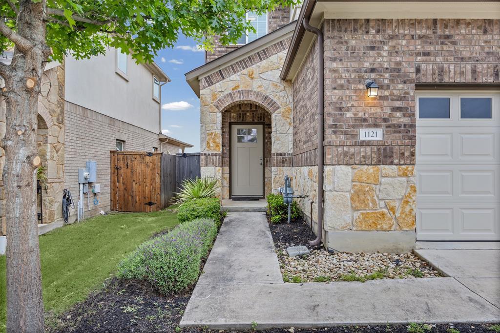 An inviting entry showcases brick and stone mason
